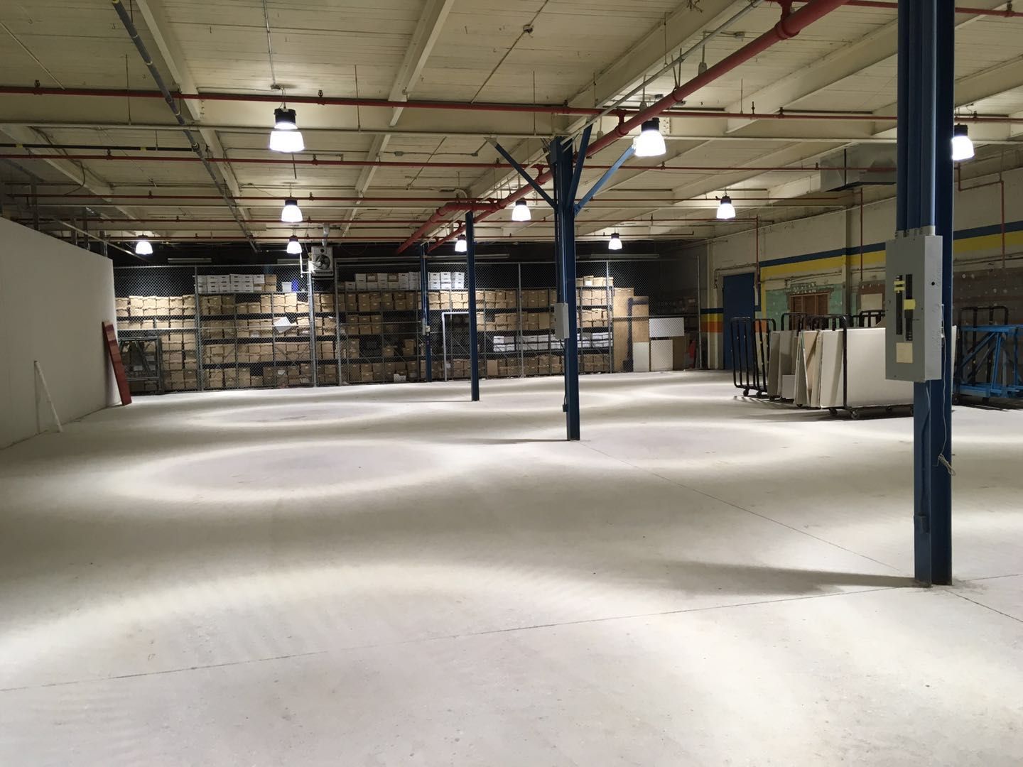 This Toronto factory renovation highlights a large open industrial space upgraded with improved lighting, structural columns, and clean finished flooring to support efficient warehouse and production operations. The renovation focuses on enhancing safety, visibility, and workflow through a well-organized layout and durable finishes suitable for heavy-duty commercial use. Completed by Reno Compass Inc., a trusted Toronto renovation company specializing in factory and commercial renovations, the project delivers a functional, modern industrial environment designed for long-term productivity and operational efficiency.