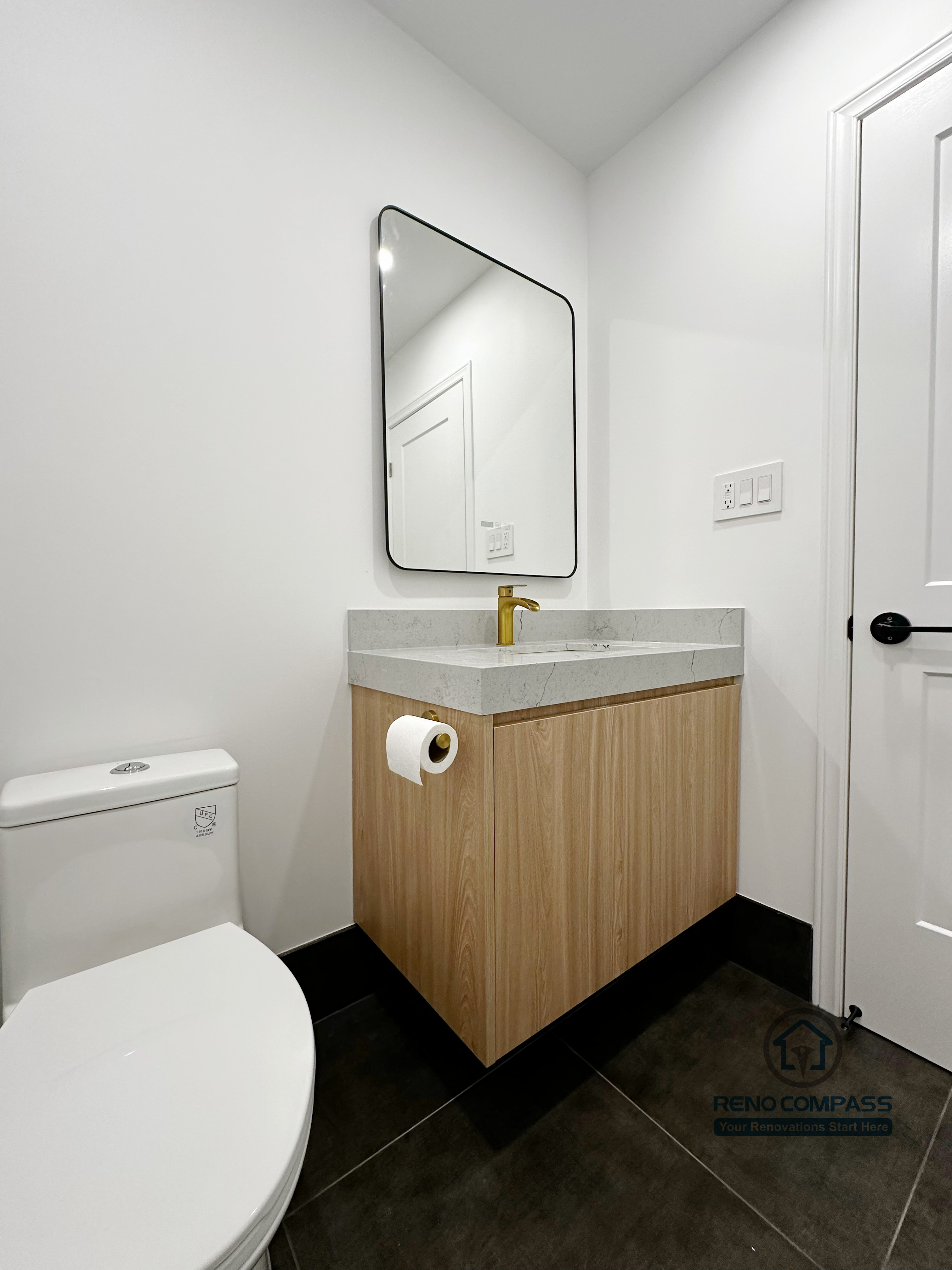 Oakville bathroom renovation featuring a compact powder room with custom vanity, quartz countertop, modern faucet, and clean minimalist layout, completed by a professional Toronto renovation company.