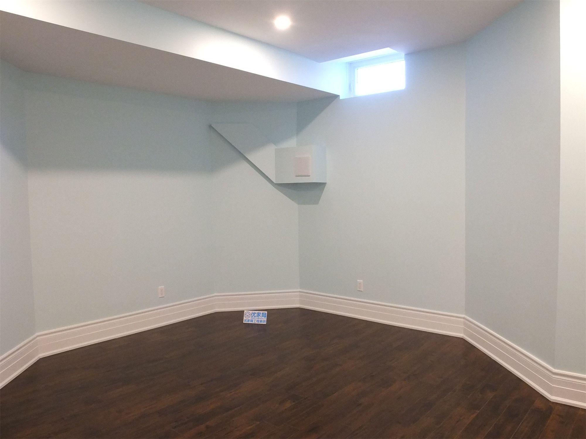 This Richmond Hill basement renovation features a newly finished bedroom space with rich hardwood flooring, smooth neutral walls, and modern recessed pot lighting. A bright basement window brings in natural light, creating a comfortable and inviting environment. The clean layout and durable finishes make this room ideal for guest accommodation, rental use, or extended family living, professionally completed to enhance both functionality and home value.