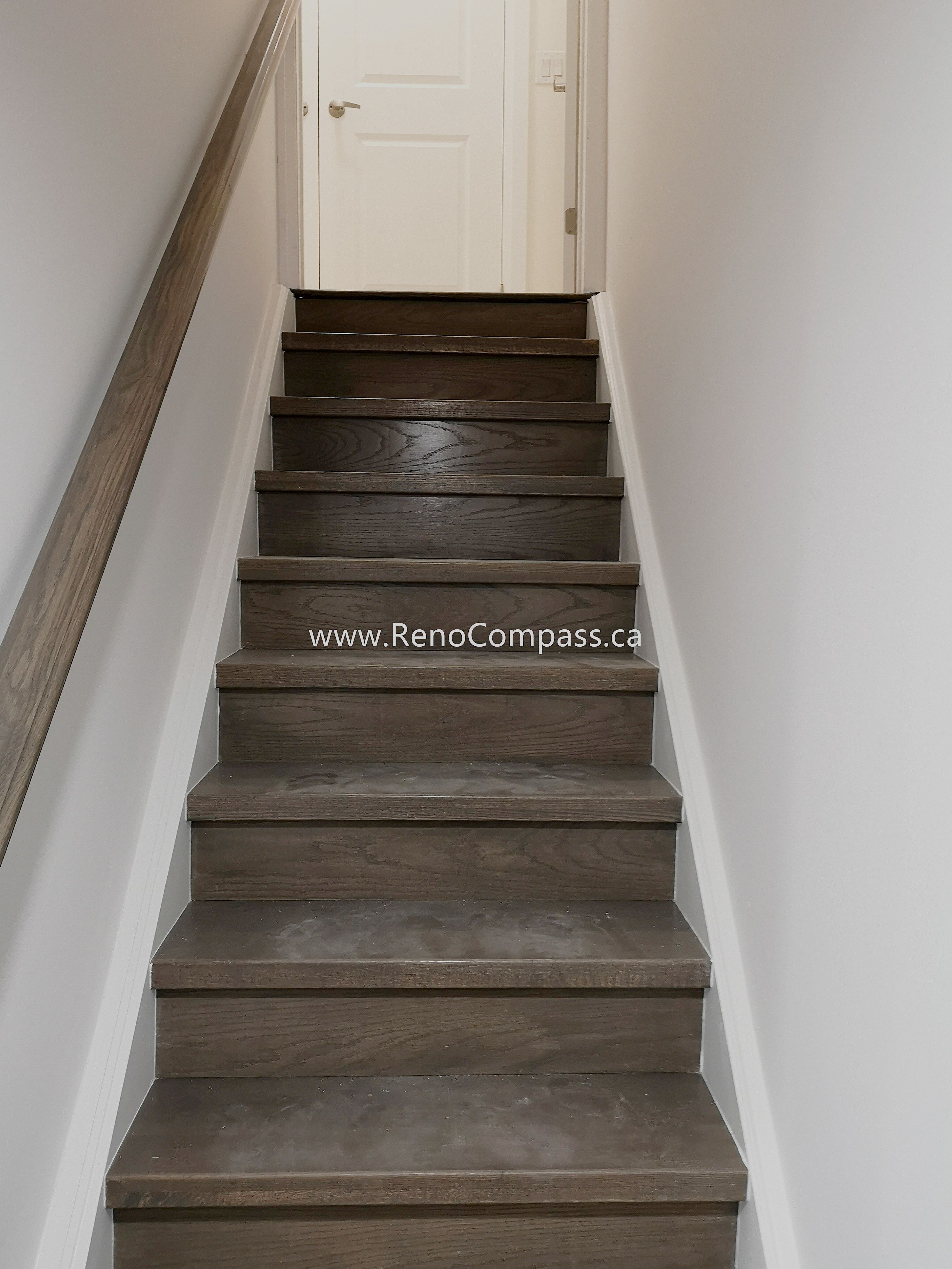 This Vaughan basement renovation includes a modern staircase upgrade featuring durable wood-style stair treads, clean white walls, and a matching handrail for a cohesive and contemporary look. The renovated staircase improves safety, accessibility, and visual flow between floors while complementing the overall basement design. Completed by Reno Compass Inc., this project highlights quality finishing and attention to detail, creating a stylish and functional transition space within the fully renovated basement.