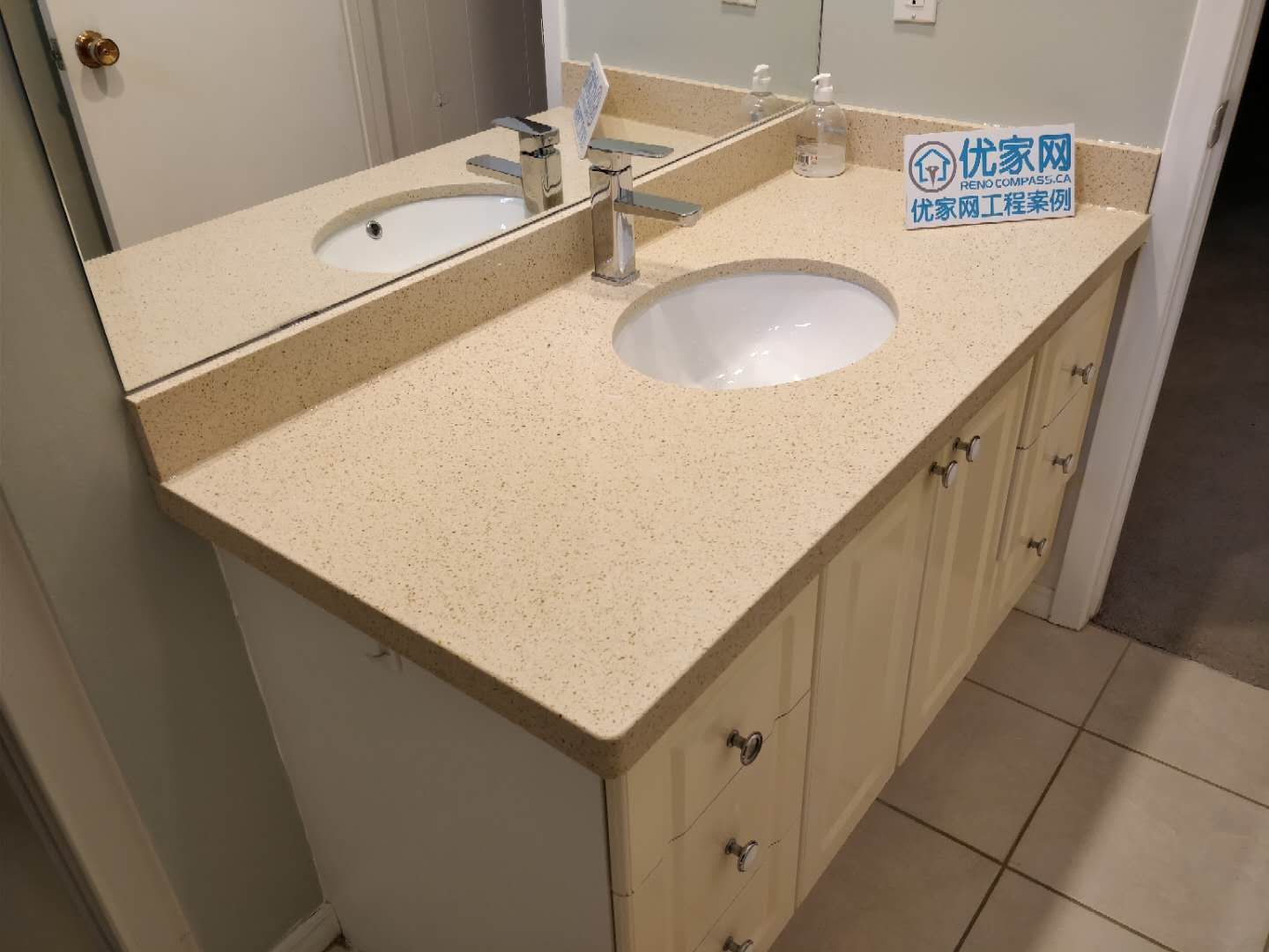 Modern bathroom vanity installed during a Scarborough interior renovation project. The design features a quartz countertop, under-mount sink, sleek chrome faucet, large wall mirror, and custom storage cabinetry, creating a clean and functional bathroom space with a bright and contemporary look.