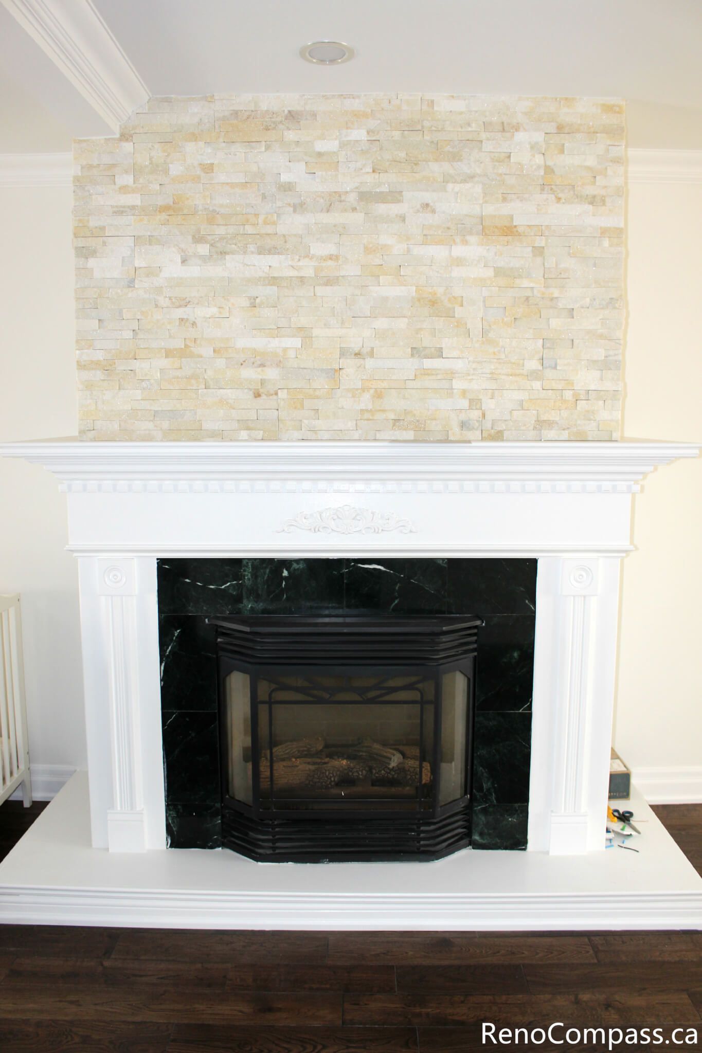 This Mississauga interior renovation showcases a beautifully upgraded fireplace area featuring a custom stone feature wall, classic white mantel design, and premium hardwood flooring. The renovation enhances the living space with a warm focal point and elegant finishes, combining modern comfort with timeless style. Completed by a professional Toronto renovation company, Reno Compass Inc., this project highlights quality craftsmanship and refined interior detailing.