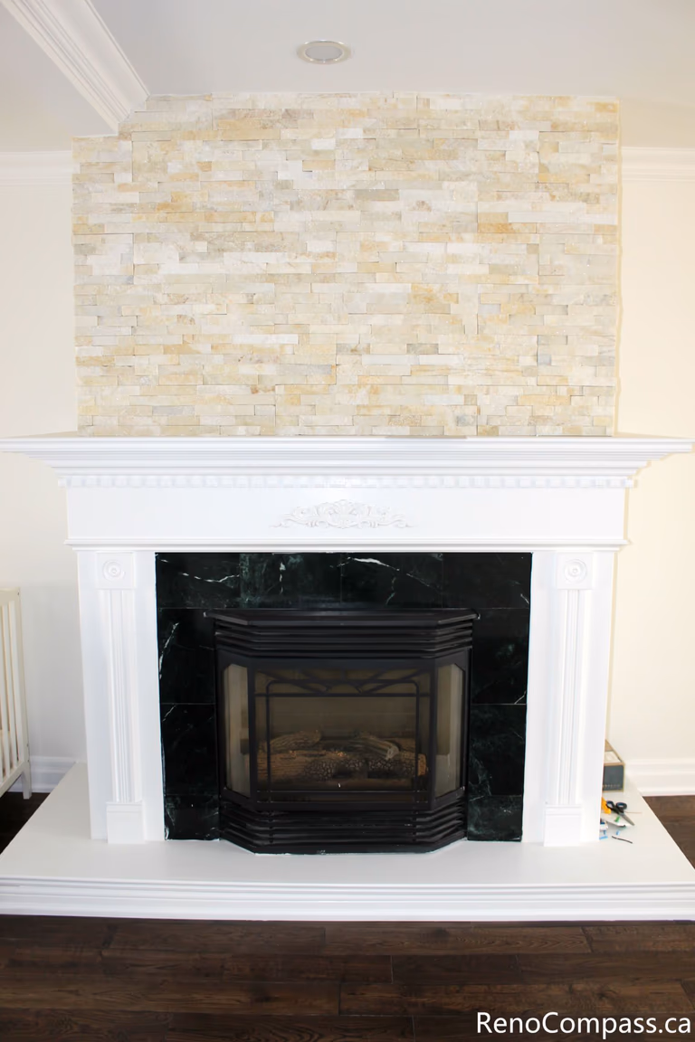 This Mississauga interior renovation showcases a beautifully upgraded fireplace area featuring a custom stone feature wall, classic white mantel design, and premium hardwood flooring. The renovation enhances the living space with a warm focal point and elegant finishes, combining modern comfort with timeless style. Completed by a professional Toronto renovation company, Reno Compass Inc., this project highlights quality craftsmanship and refined interior detailing.