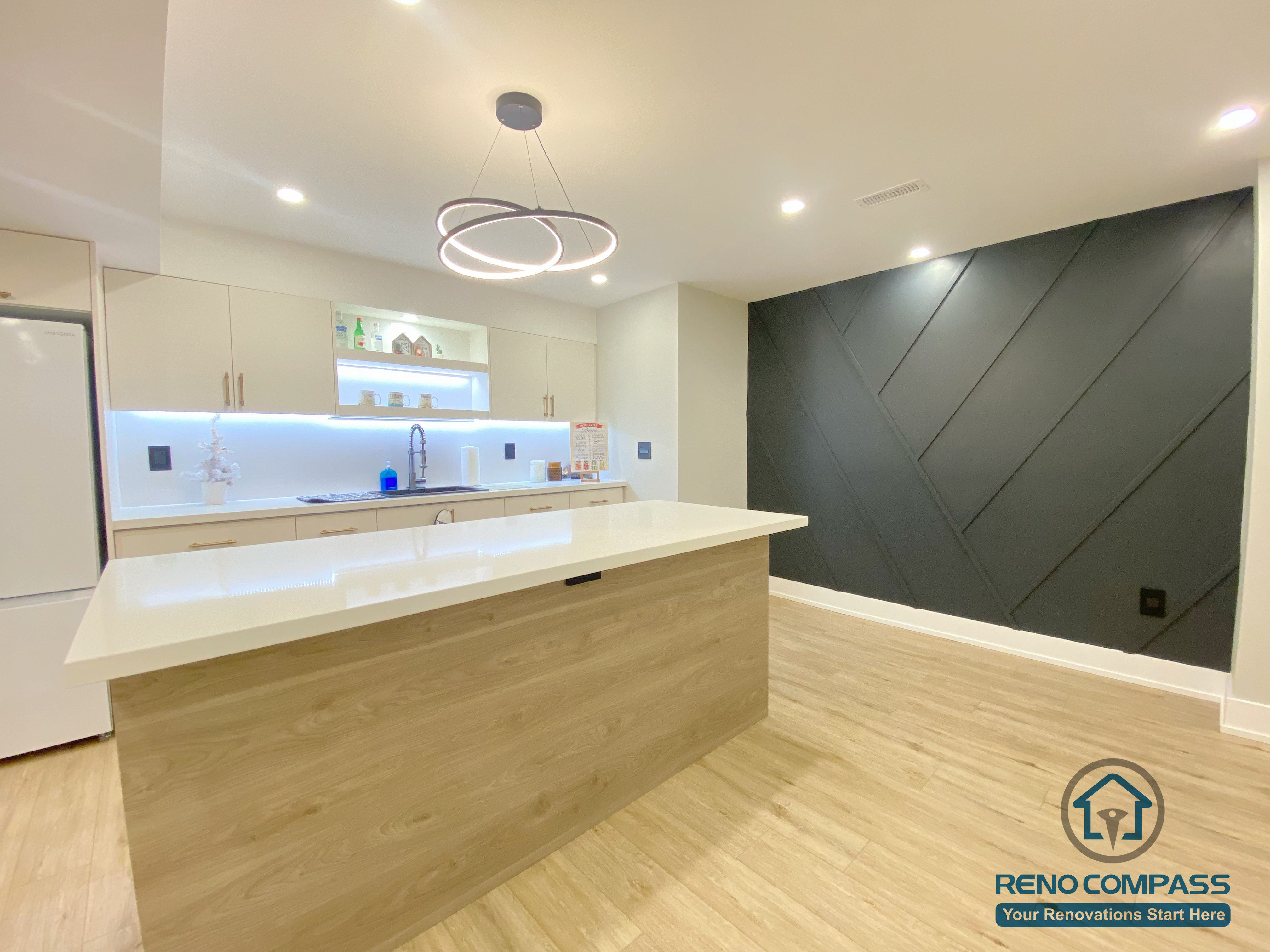 This Aurora basement renovation features a modern open-concept layout with a custom kitchen island, wood-tone cabinetry, integrated LED lighting, and clean contemporary finishes. Designed to maximize brightness and functionality, the space blends living, dining, and kitchen areas seamlessly, creating a comfortable and practical lower-level living environment. Completed by a Toronto renovation company, this basement renovation demonstrates thoughtful space planning and modern design execution.