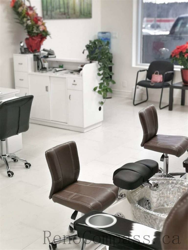Toronto nail spa commercial renovation featuring a clean and welcoming reception counter, modern cabinetry, and a bright pedicure area with ergonomic client seating and integrated spa basins. The upgraded salon interior emphasizes hygiene, comfort, and efficient layout planning to enhance daily operations. Commercial beauty salon renovation completed by Reno Compass Inc., a professional Toronto renovation company specializing in nail spa and retail spaces.