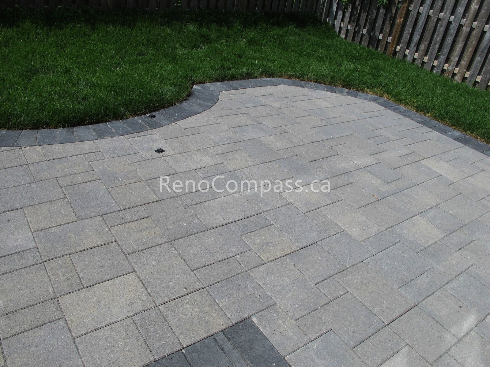 This Vaughan landscaping renovation features a professionally installed interlocking stone patio designed for durability and outdoor comfort. The clean layout, modern paving pattern, and contrasting border stones enhance both functionality and curb appeal, creating a perfect backyard space for relaxation and entertaining.