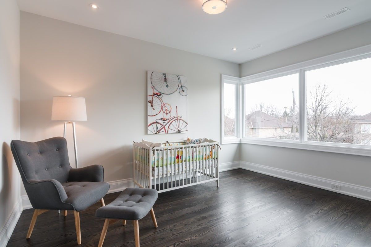 This bright and comfortable nursery room is part of a 4,500 sq ft luxury home renovation in Toronto. Designed with large corner windows and warm hardwood flooring, the space offers a calm and welcoming environment for modern family living. Clean wall finishes and thoughtful layout planning enhance both natural light and functionality. Completed by a professional Toronto Renovation Company, Reno Compass Inc., this project reflects quality craftsmanship and contemporary residential design tailored for growing families.