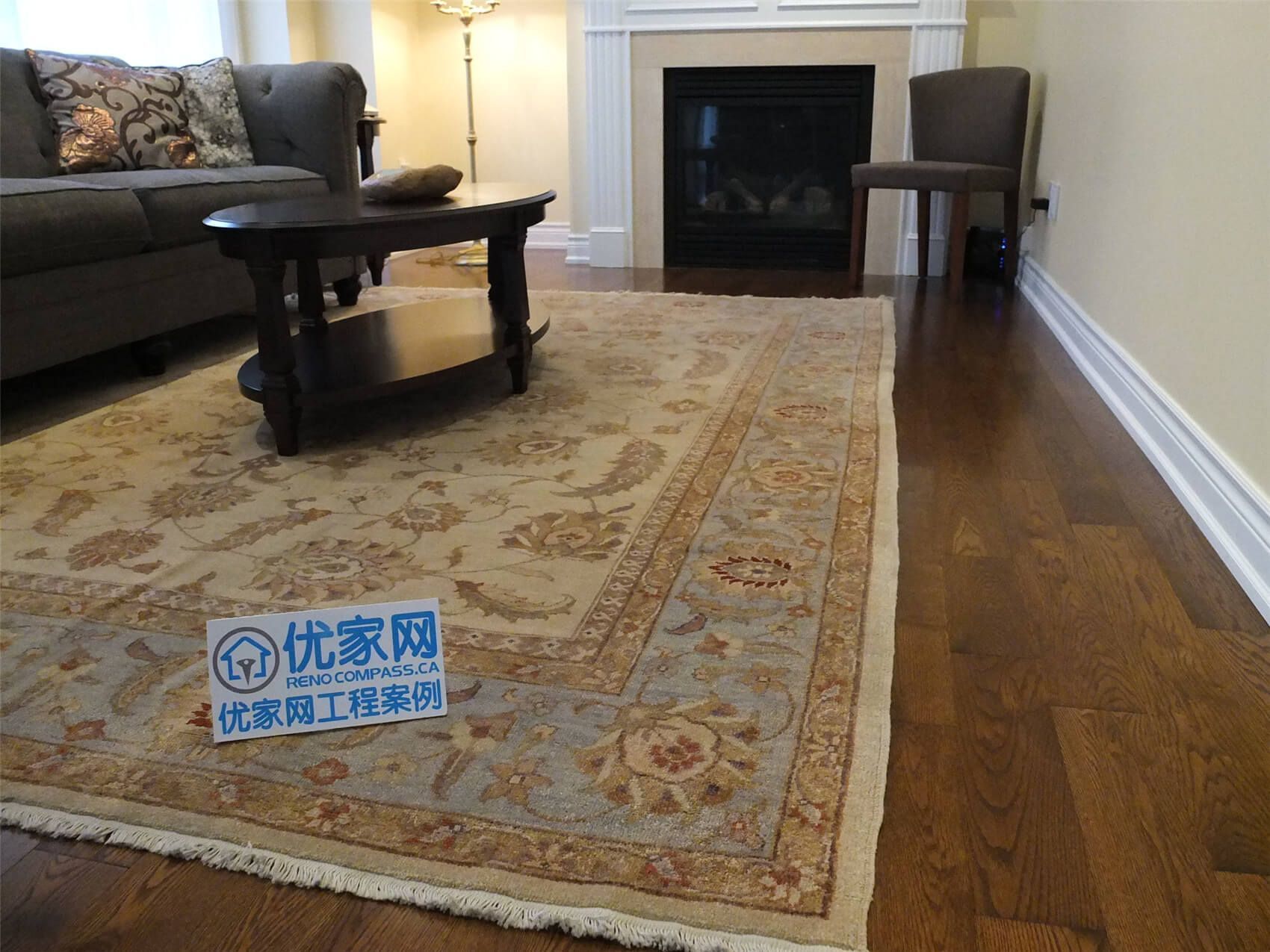 This Aurora flooring renovation showcases newly installed hardwood flooring in a cozy living room space featuring a classic fireplace and elegant seating area. The rich wood flooring enhances the warmth of the room and pairs beautifully with the neutral wall tones and traditional décor. Completed by a trusted Toronto renovation company, the flooring upgrade improves both the visual appeal and long-term durability of this comfortable living area.