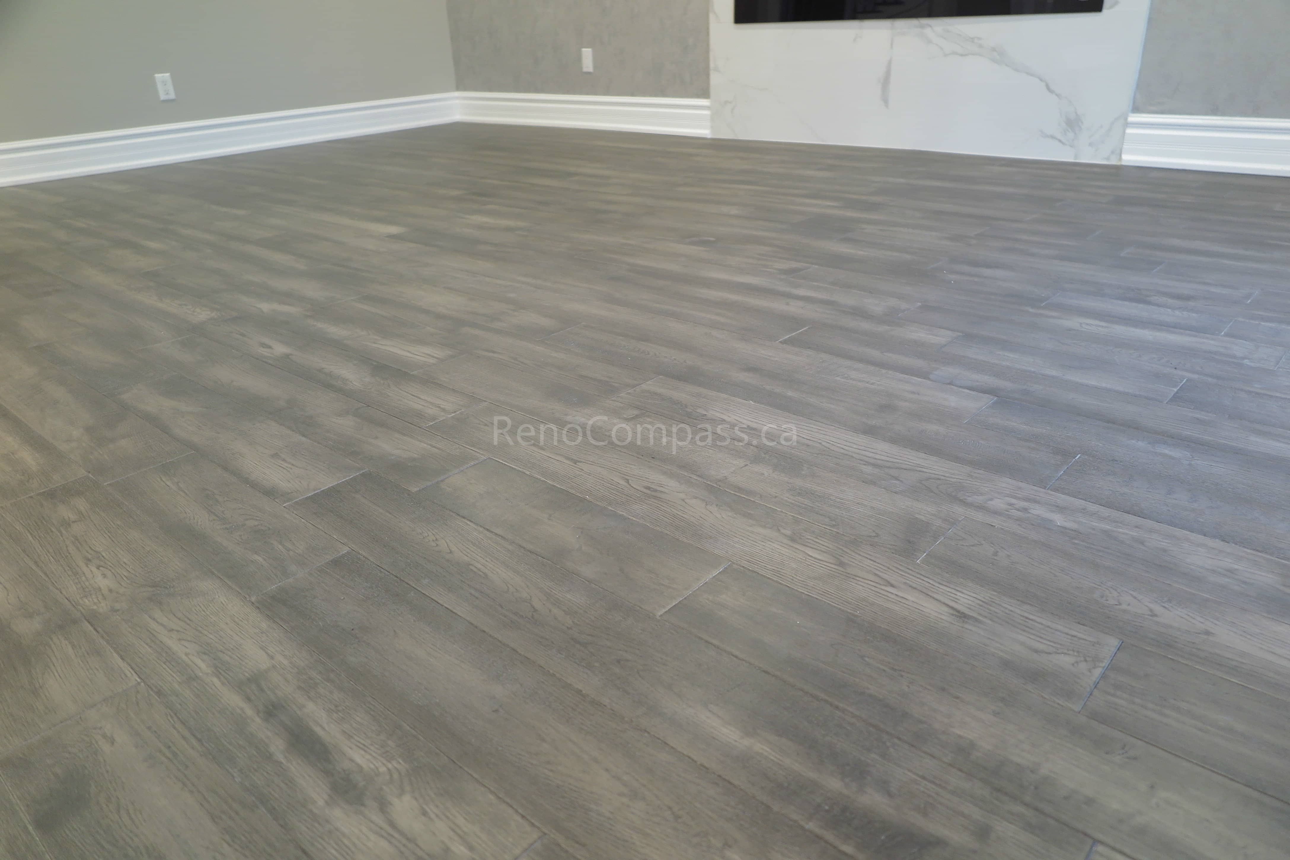 This Markham interior renovation highlights newly installed modern vinyl flooring with a natural wood-grain finish, designed for durability and contemporary style. The flooring enhances the open living space while complementing neutral wall tones, clean baseboard trim, and modern interior finishes. Completed by Reno Compass, a professional renovation contractor specializing in flooring installation and full interior renovations across Markham and the Greater Toronto Area.