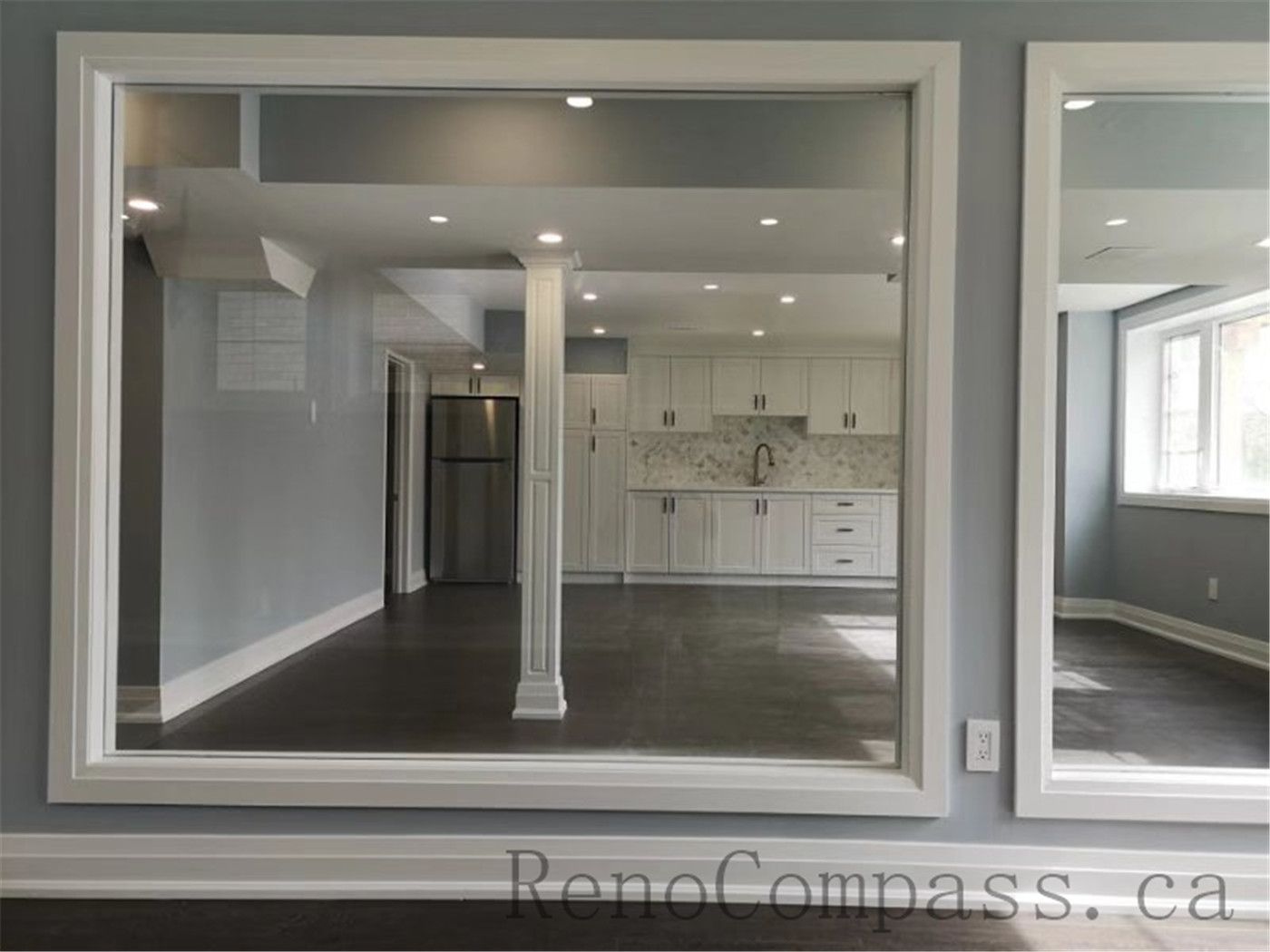 This cozy basement lounge in Aurora features elegant wall finishes, large windows, and modern flooring. The space is designed to bring warmth and openness, beautifully finished by Reno Compass.