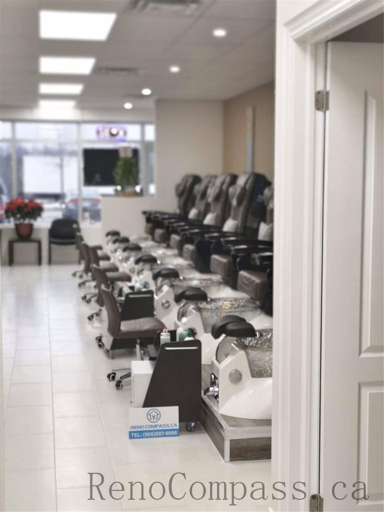 Professional Toronto nail salon commercial renovation showcasing a spacious pedicure area with multiple luxury massage chairs, modern spa basins, and a bright open layout. The upgraded beauty space focuses on customer comfort, efficient workflow, and a clean contemporary design ideal for high-end nail spa operations. Completed by Reno Compass Inc., a trusted Toronto renovation company specializing in nail salon and commercial interior renovations.