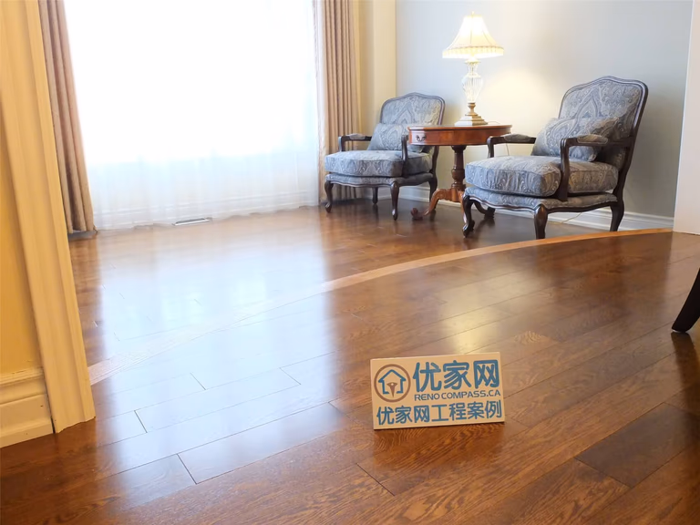 This Aurora flooring renovation highlights the installation of rich hardwood flooring that enhances the warmth and sophistication of the living room area. The smooth wood planks reflect natural light from the large window, creating a bright and inviting atmosphere. Completed by a professional Toronto renovation company, this flooring upgrade improves durability, visual appeal, and the overall comfort of the home’s interior space.