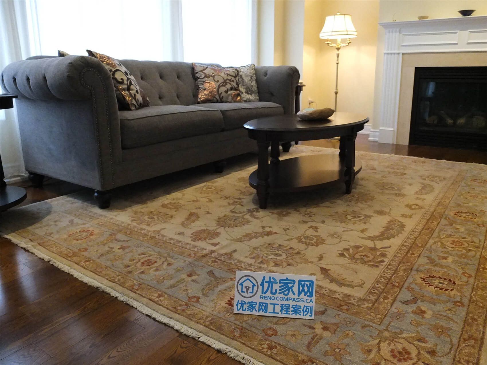 This Aurora flooring renovation showcases newly installed hardwood flooring in a cozy living room space featuring a classic fireplace and elegant seating area. The rich wood flooring enhances the warmth of the room and pairs beautifully with the neutral wall tones and traditional décor. Completed by a trusted Toronto renovation company, the flooring upgrade improves both the visual appeal and long-term durability of this comfortable living area.