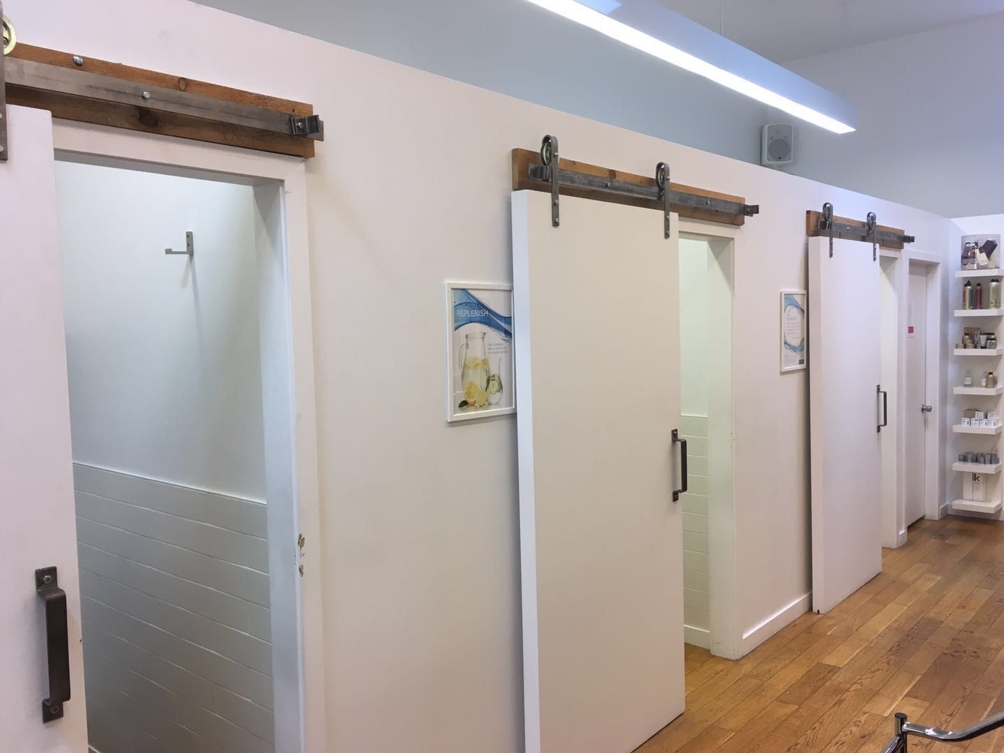 This Toronto spa renovation features a sleek and functional salon setup with modern black washing stations, custom cabinetry, and a clean workspace layout. Designed for both efficiency and aesthetics, the space enhances client comfort while maintaining a professional, high-end appearance.