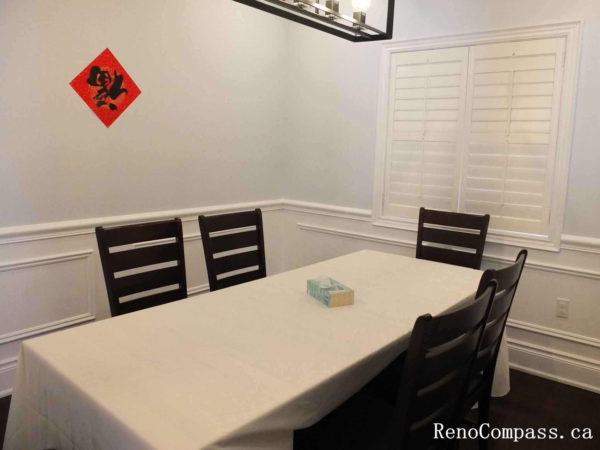 Formal dining room renovation in Newmarket featuring custom wall panel molding, recessed pot lights, modern pendant lighting, hardwood flooring, and a clean symmetrical layout. Completed by a trusted Toronto Renovation Company, this interior upgrade enhances elegance and everyday functionality.