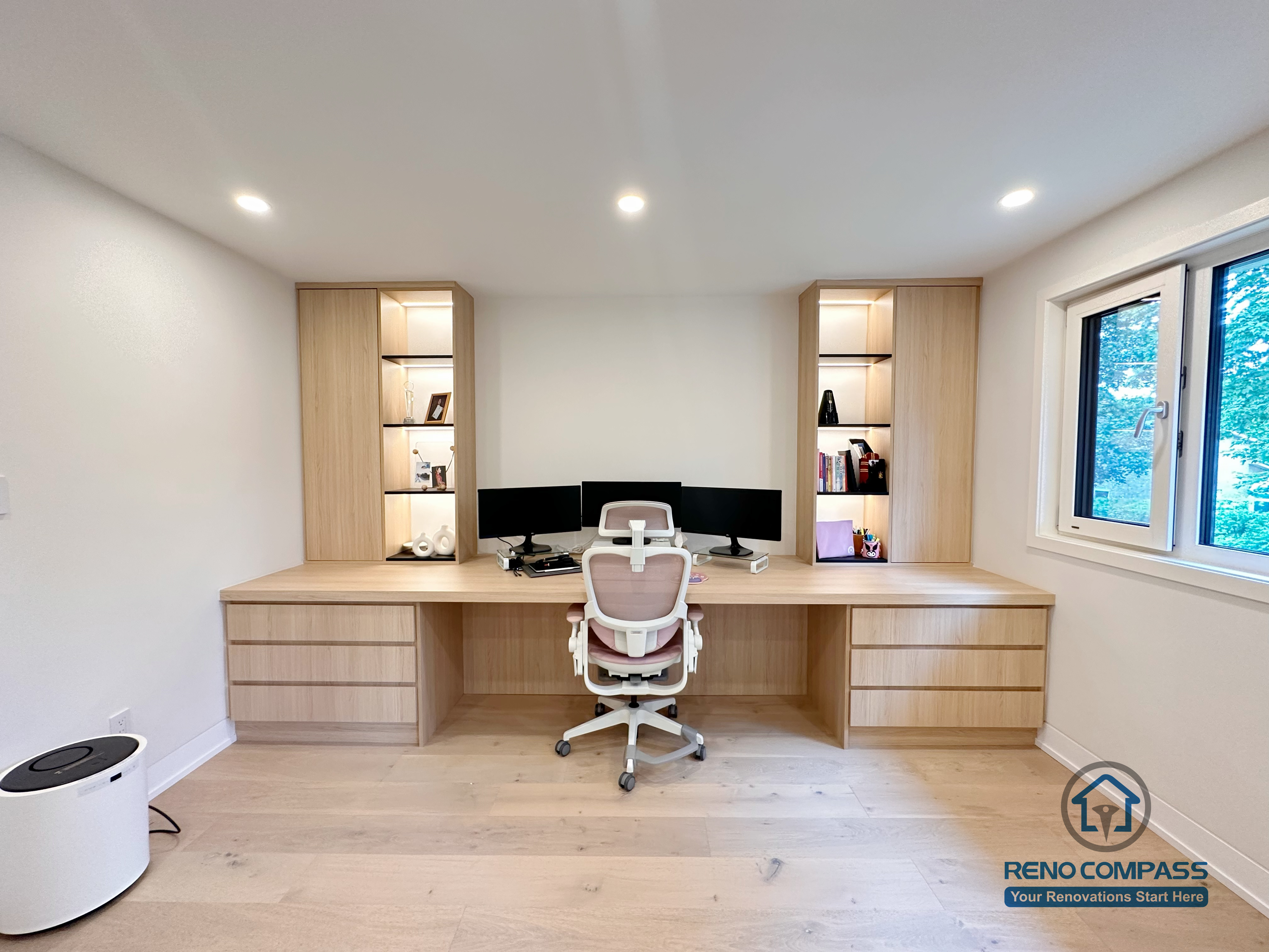 A custom home office renovation in Toronto featuring a built-in desk, integrated drawer storage, and vertical cabinetry with accent shelving. This bespoke workspace design maximizes functionality while maintaining a clean, modern aesthetic, completed by a professional Toronto renovation company.