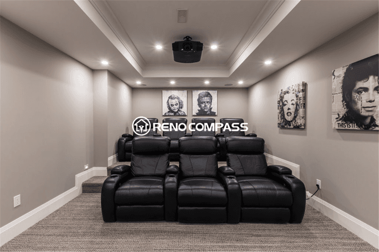 Luxury basement home theater renovation in Toronto featuring a custom cinema room with tiered seating, leather recliners, recessed lighting, and ceiling-mounted projector system. This professionally designed entertainment space was completed by a trusted Toronto renovation company, Reno Compass Inc., creating a premium movie experience at home.