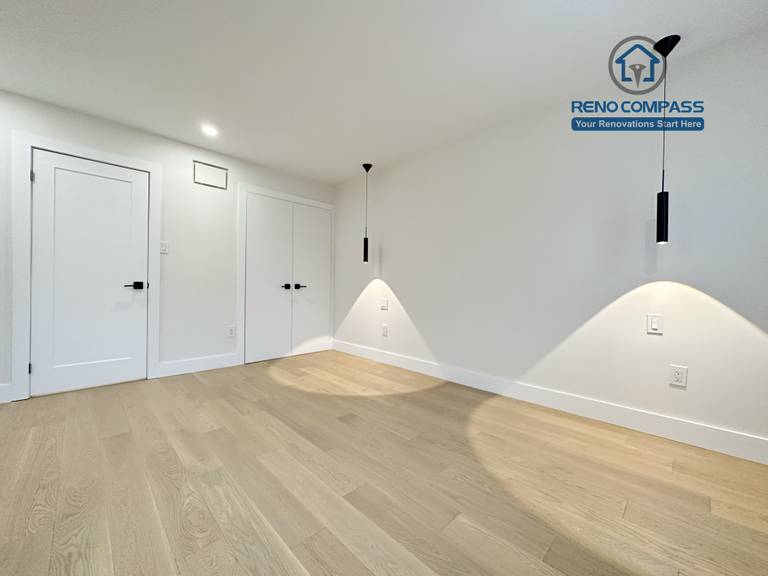 Modern bedroom renovation in a Richmond Hill home featuring light-tone hardwood flooring, minimalist pendant accent lighting, clean white walls, and a sleek, contemporary interior finish.