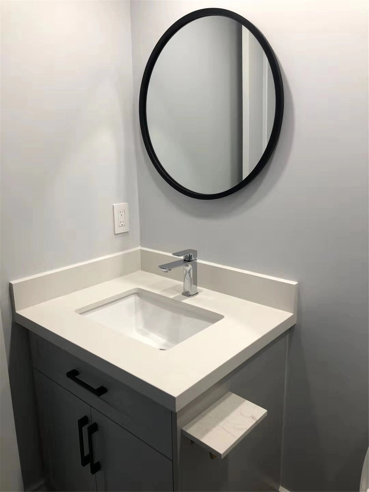 Modern bathroom vanity installation in a Richmond Hill condo renovation project. The upgrade features a clean white quartz countertop, integrated sink, contemporary faucet, and custom vanity cabinet with practical storage. This renovation enhances both functionality and visual appeal, creating a bright and minimalist bathroom space suitable for modern condo living.
