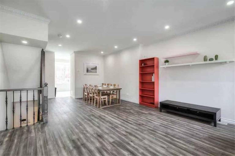 This Thornhill interior renovation showcases a spacious living room upgrade featuring new vinyl flooring, fresh wall painting, modern pot lights, and a refreshed fireplace feature wall. Large windows and sliding patio doors enhance natural light and openness, creating a bright and welcoming environment. Completed by a professional Toronto renovation team, this renovation highlights quality craftsmanship and modern interior design for comfortable family living.