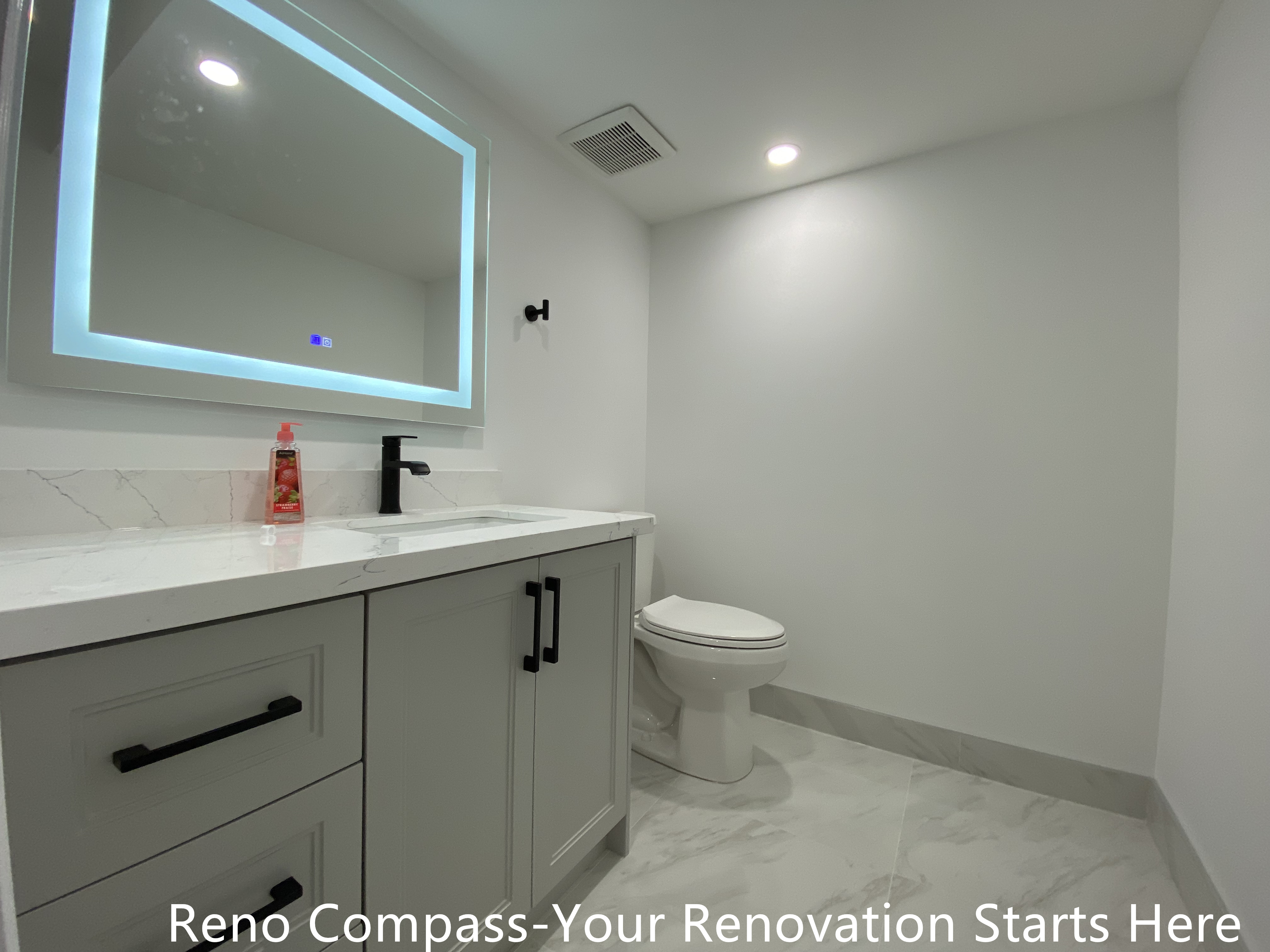 This Bradford basement bathroom renovation features a modern floating vanity, quartz countertop, matte black fixtures, and large-format tile flooring. Designed for durability and easy maintenance, this space enhances everyday functionality while maintaining a clean, contemporary look as part of a full basement renovation by a Toronto renovation company.