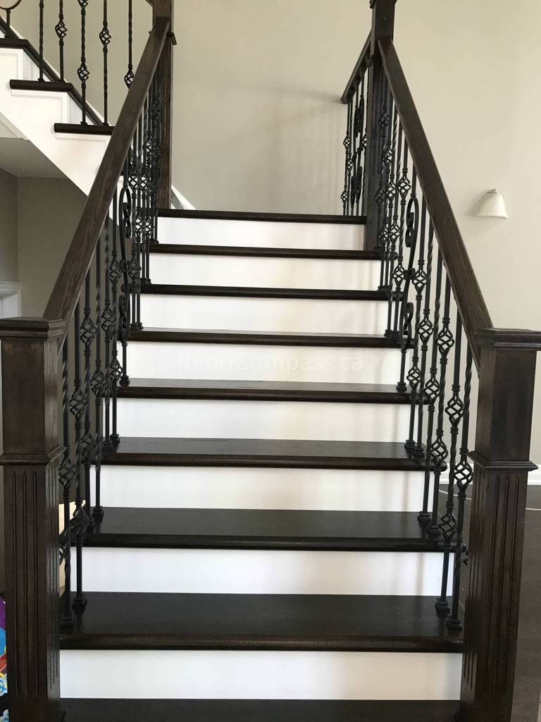 This Markham home renovation features a beautifully upgraded hardwood staircase with dark wood stair treads and elegant wrought iron railings. The contrast between the rich flooring and bright risers creates a clean, modern, and sophisticated visual impact. Completed by a trusted Toronto renovation company, this staircase upgrade enhances both safety and interior aesthetics while maintaining a cohesive flooring design throughout the home.