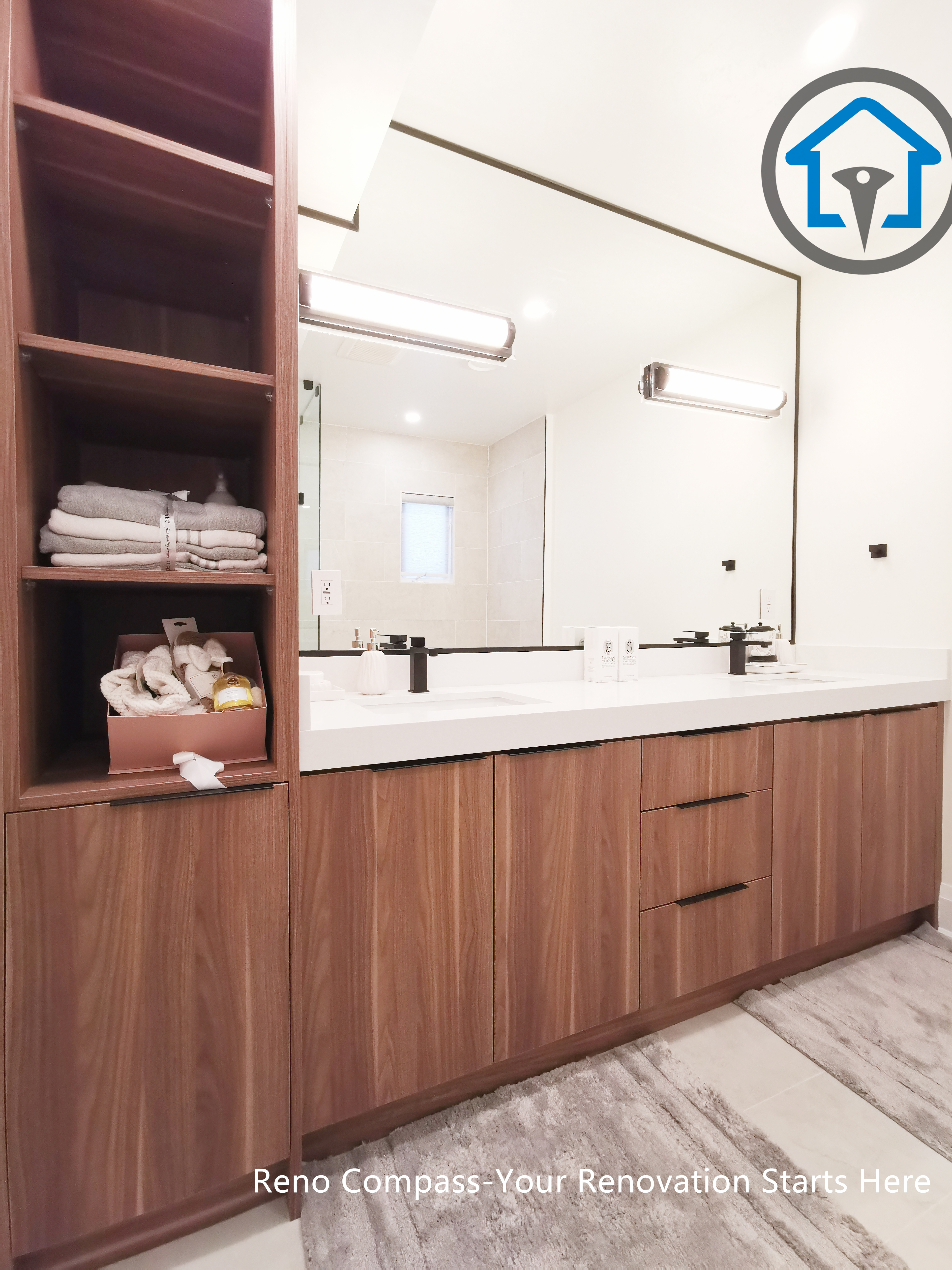 This North York bathroom renovation highlights a custom wood vanity with double sinks, integrated open shelving, and a quartz countertop. Warm wood finishes are paired with clean white surfaces and modern lighting, creating a balanced and highly functional bathroom space. Completed by a Toronto renovation company focused on craftsmanship, storage optimization, and long-term usability.
