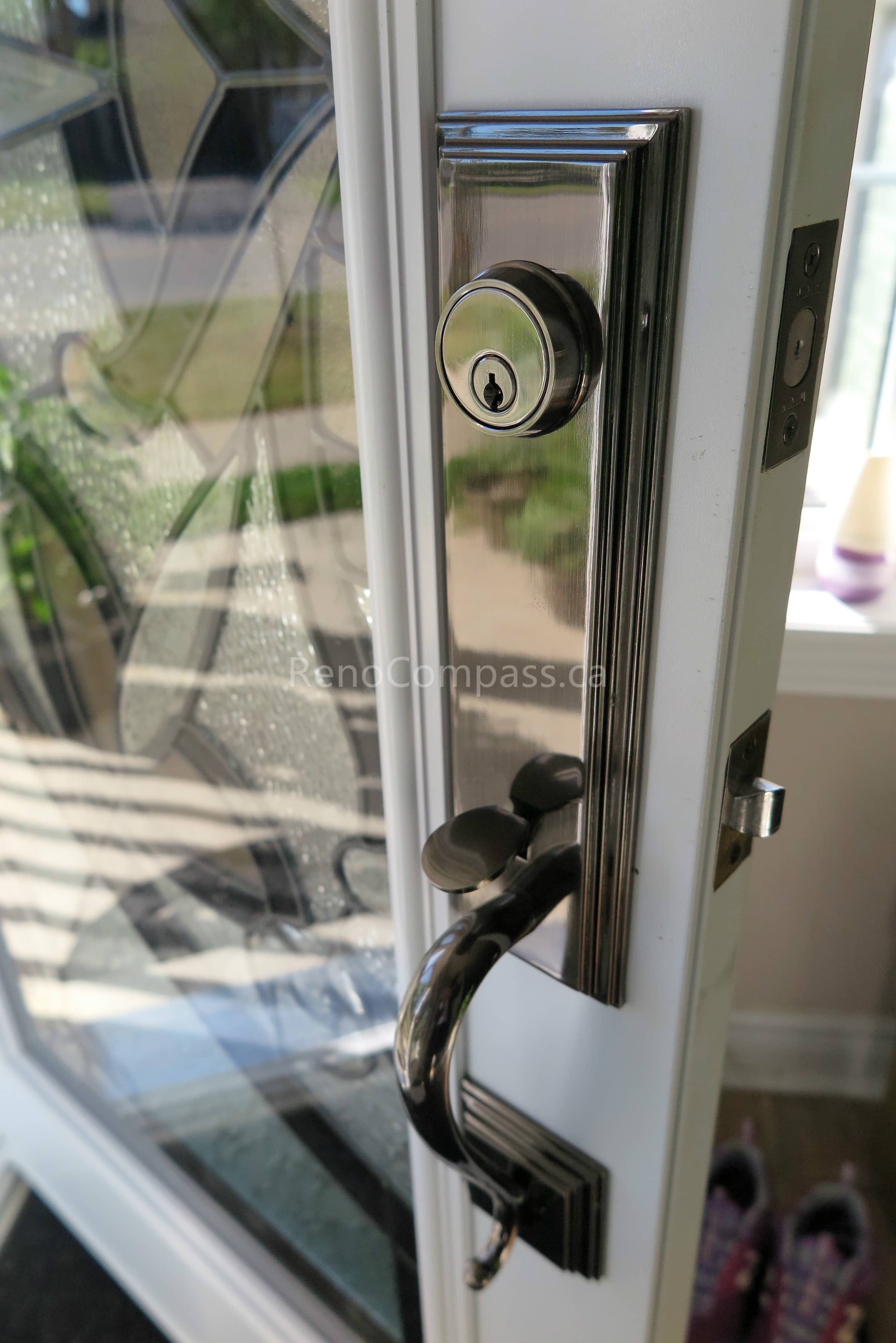 Close-up detail of newly installed double entry door hardware in a New market home, featuring modern black handles and secure locking systems paired with decorative privacy glass panels. Completed by a professional Toronto Renovation Company, this door upgrade enhances both security and visual appeal while adding a refined, high-end finish to the home’s main entrance.