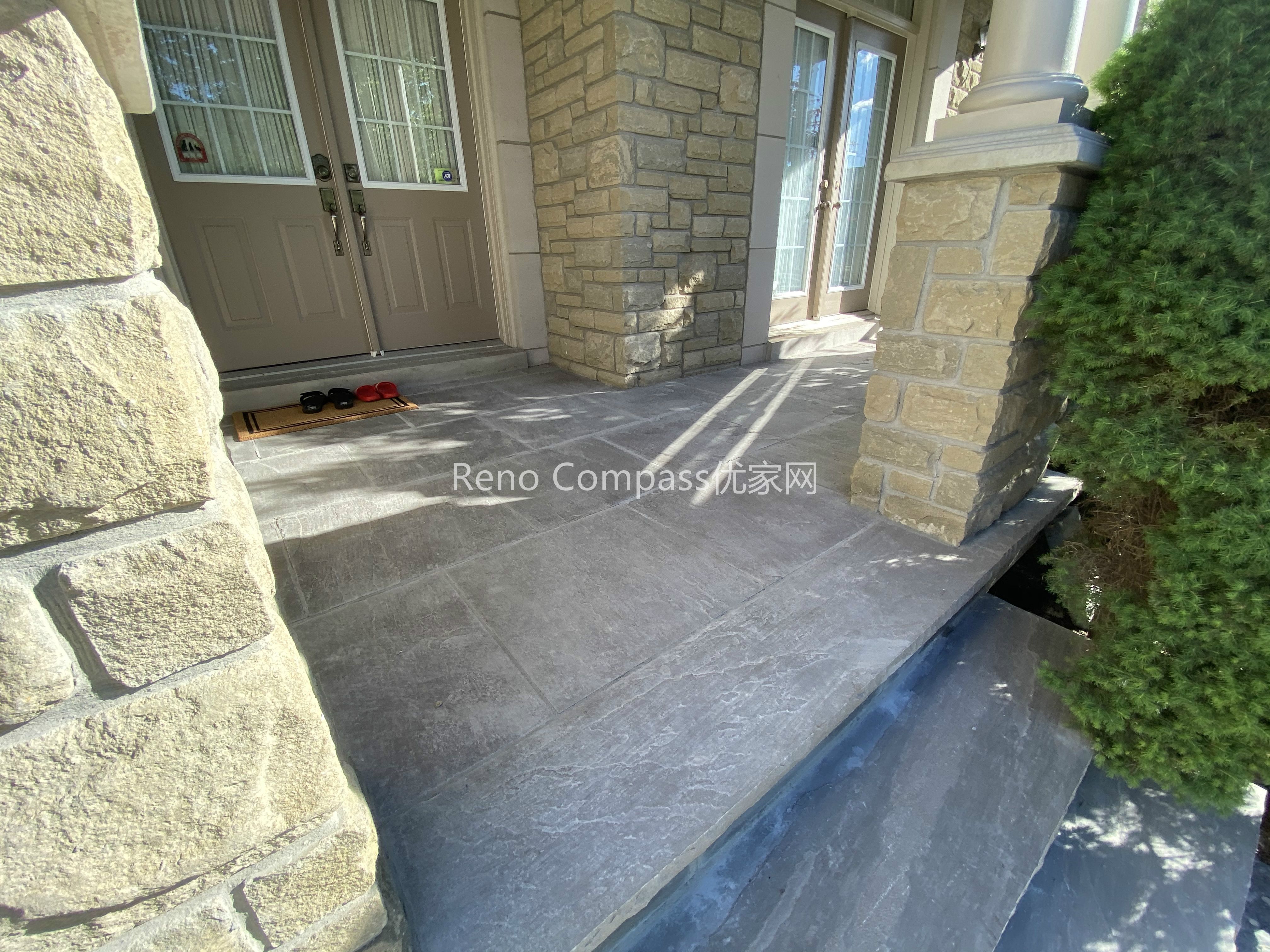 This image showcases the natural stone front entrance steps completed as part of a North York driveway interlocking project. Large-format stone slabs are carefully installed to create solid, level steps that provide safe and comfortable access to the home’s main entrance. The stone steps integrate seamlessly with the home’s stone façade and surrounding interlocking surfaces, ensuring visual continuity and structural stability. Designed for durability and year-round use, these entrance steps enhance curb appeal while maintaining proper rise, tread depth, and drainage. Completed by a Toronto interlocking and landscaping contractor, this project reflects precision craftsmanship and attention to exterior detailing.