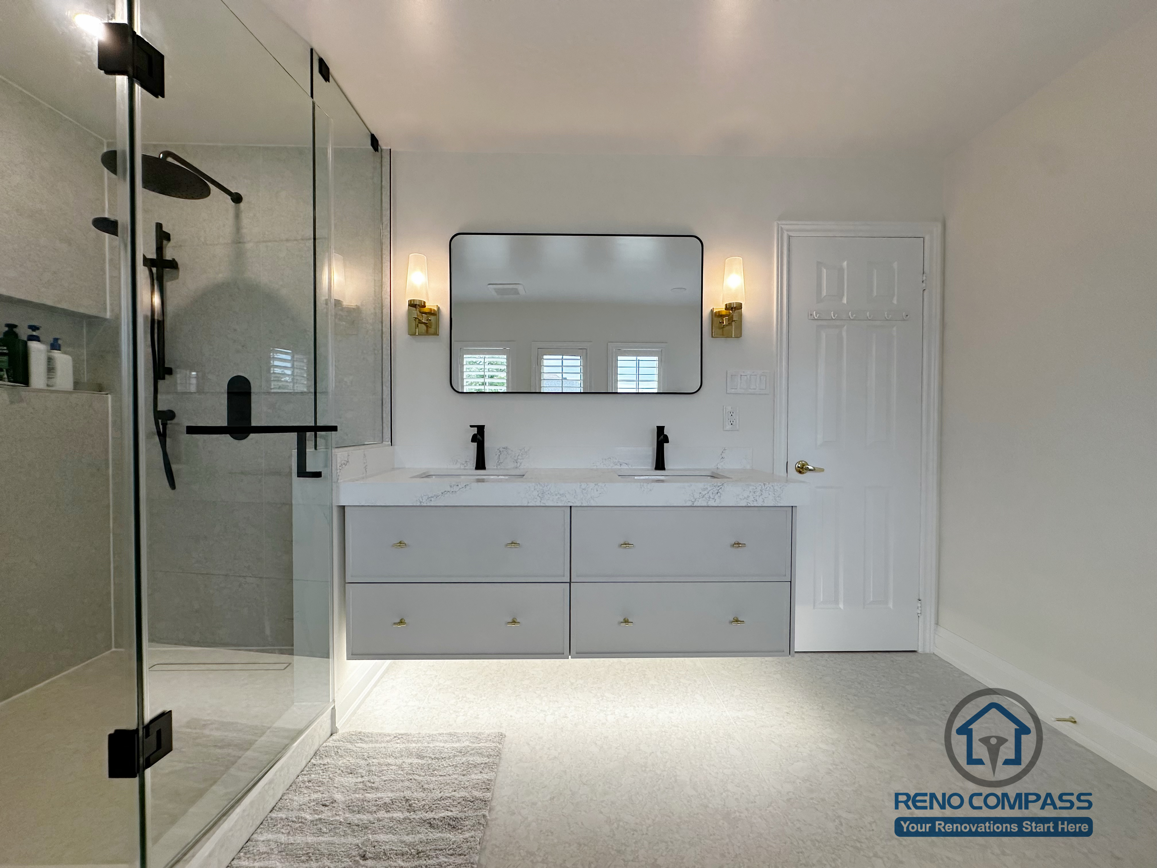 This Markham bathroom renovation showcases a balanced layout featuring a double vanity with quartz countertops, warm wall sconces, and a clean-lined glass shower enclosure. The neutral palette and soft lighting create a calm, refined atmosphere designed for long-term comfort and everyday practicality.