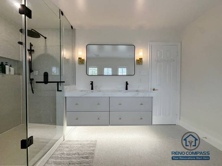This Markham bathroom renovation showcases a balanced layout featuring a double vanity with quartz countertops, warm wall sconces, and a clean-lined glass shower enclosure. The neutral palette and soft lighting create a calm, refined atmosphere designed for long-term comfort and everyday practicality.