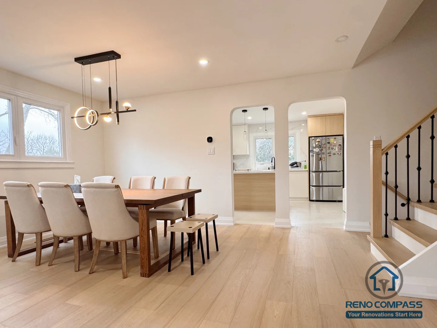 This Oakville interior renovation features a bright, modern kitchen with a waterfall island, custom cabinetry, and clean integrated finishes. The layout balances everyday functionality with a refined, minimalist aesthetic, creating a welcoming and highly practical cooking space.