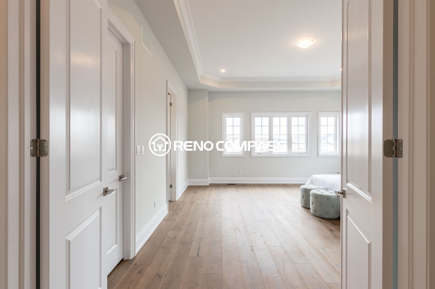 This image shows a bedroom flooring renovation in a Newmarket home, featuring professionally installed engineered wood flooring. The natural wood finish enhances the brightness and comfort of the interior space. The project was completed by Reno Compass Inc., a Toronto renovation company specializing in flooring and interior renovations.