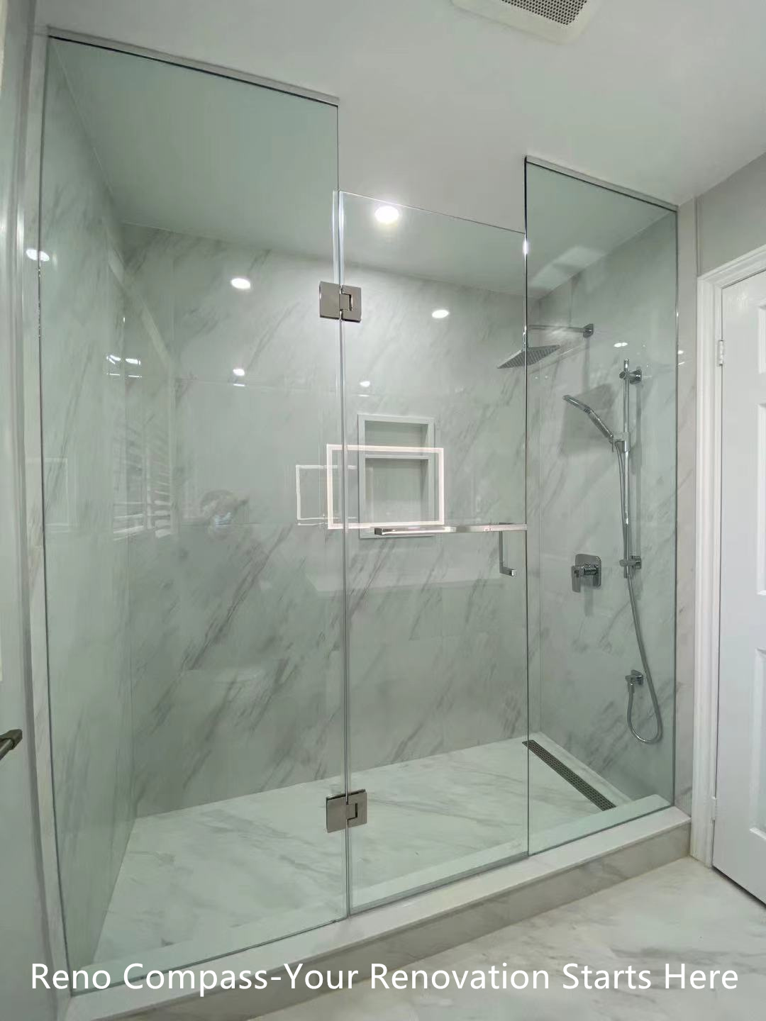 This Oakville interior renovation features a modern walk-in shower designed with frameless glass panels and full-height marble-look porcelain tiles. The clean glass enclosure enhances visual openness while allowing natural and artificial light to flow through the space. A rain shower system, wall-mounted hand shower, and built-in niche provide both comfort and functionality. The minimalist layout and neutral stone tones create a calm, spa-inspired bathroom environment that is durable, easy to maintain, and ideal for long-term residential use. This project reflects the precision detailing and modern design standards expected from a professional Toronto renovation company.