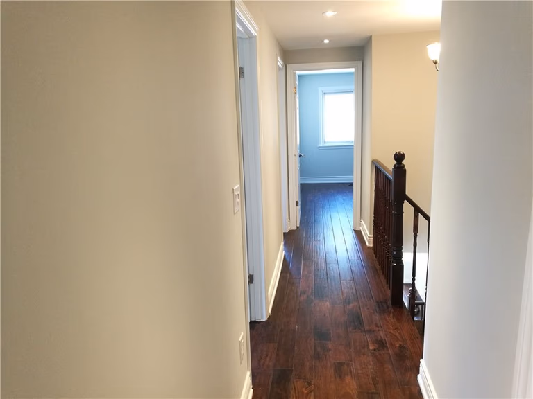 Scarborough whole-house interior renovation featuring new hardwood flooring installation and upgraded hallway design. This project highlights modern lighting, smooth wall finishing, and refined staircase detailing, creating a bright and cohesive interior space by a professional Toronto renovation contractor.