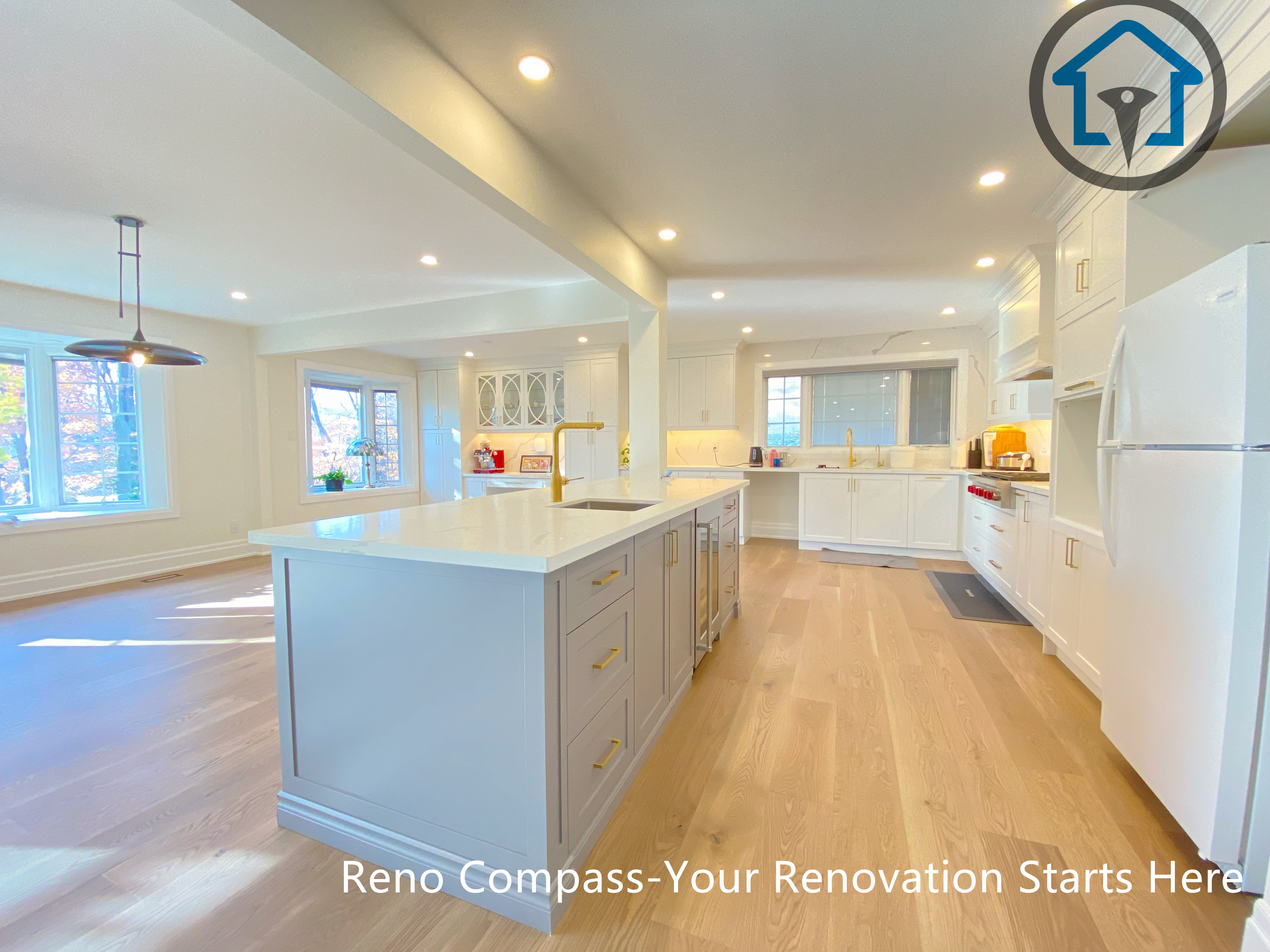 This North York house interior renovation features an open-concept kitchen centered around a large functional island. Custom cabinetry, warm wood flooring, and recessed lighting create a bright and inviting space that connects seamlessly with the surrounding living and dining areas, making the kitchen a central hub for daily family life and entertaining.
