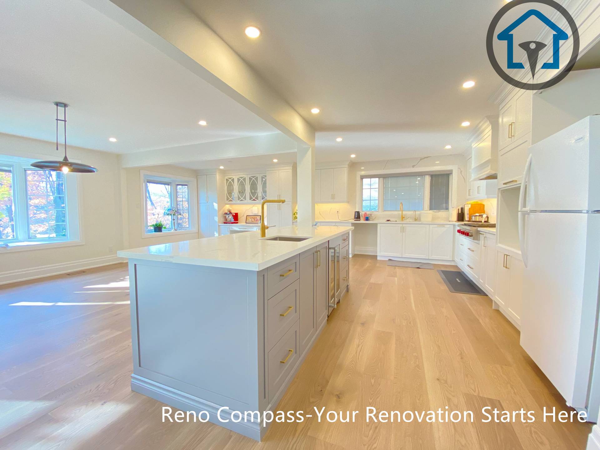 This North York house interior renovation features an open-concept kitchen centered around a large functional island. Custom cabinetry, warm wood flooring, and recessed lighting create a bright and inviting space that connects seamlessly with the surrounding living and dining areas, making the kitchen a central hub for daily family life and entertaining.