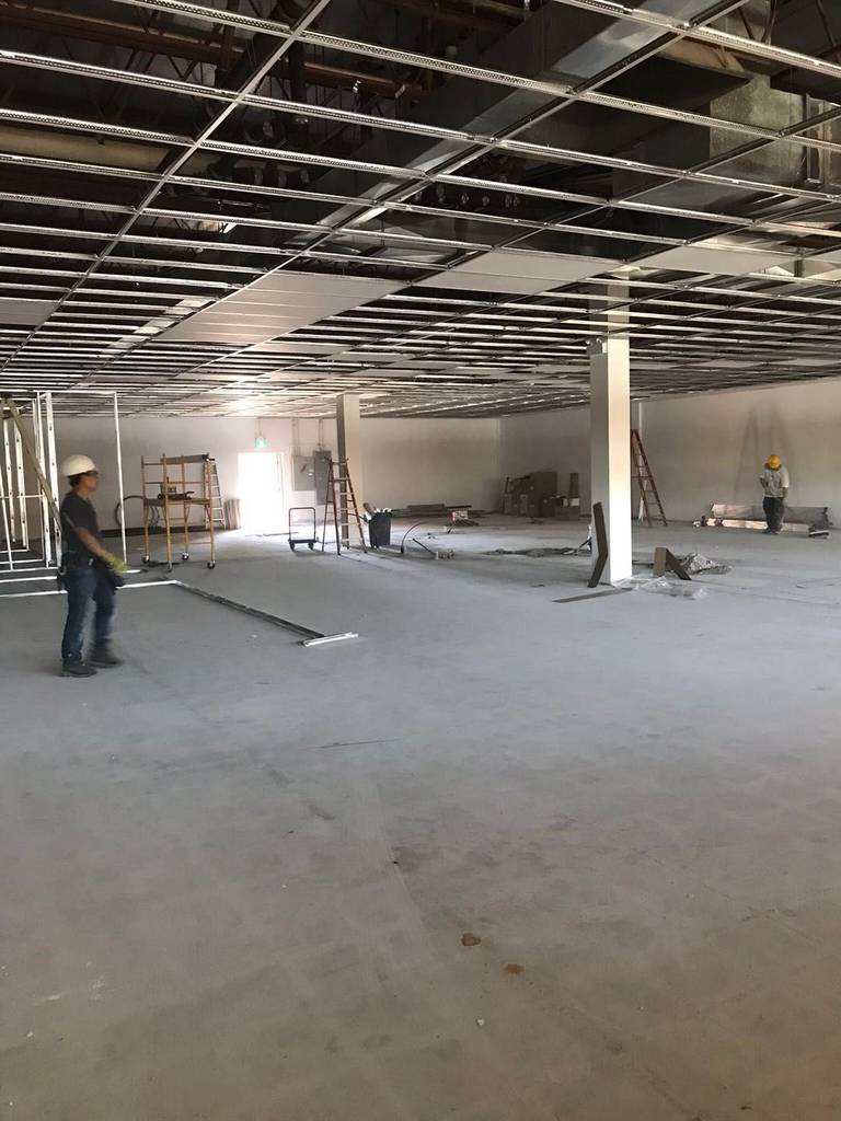 This Toronto commercial renovation project highlights the active construction phase of a large commercial unit undergoing full interior build-out. The suspended ceiling grid system has been installed to accommodate lighting, HVAC routing, and fire protection systems, ensuring compliance with commercial building standards in Toronto.

The open floor layout allows flexibility for office partitions, retail configuration, or professional workspace planning. Skilled trades are coordinating framing, ceiling preparation, and floor layout to create a structured and efficient commercial environment. This stage reflects detailed planning and quality execution, forming the foundation for a modern, high-performance business space in the GTA.