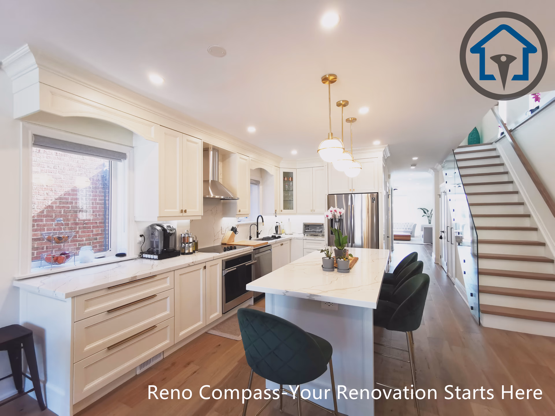 This image captures a layered perspective of the kitchen in a North York interior renovation, showcasing the relationship between the main countertop, central island, and staircase. The custom island features quartz surfaces, built-in storage, and seating, highlighted by warm pendant lighting above. White shaker cabinetry and stainless steel appliances create a clean, timeless backdrop, while continuous hardwood flooring enhances spatial flow. The open staircase and adjacent art wall add depth and visual interest without interrupting circulation. Completed by a Toronto renovation company, this renovation reflects careful planning, functional zoning, and a refined open-concept interior design.
