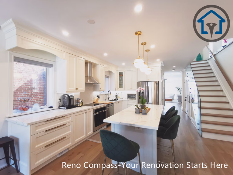 This image captures a layered perspective of the kitchen in a North York interior renovation, showcasing the relationship between the main countertop, central island, and staircase. The custom island features quartz surfaces, built-in storage, and seating, highlighted by warm pendant lighting above. White shaker cabinetry and stainless steel appliances create a clean, timeless backdrop, while continuous hardwood flooring enhances spatial flow. The open staircase and adjacent art wall add depth and visual interest without interrupting circulation. Completed by a Toronto renovation company, this renovation reflects careful planning, functional zoning, and a refined open-concept interior design.