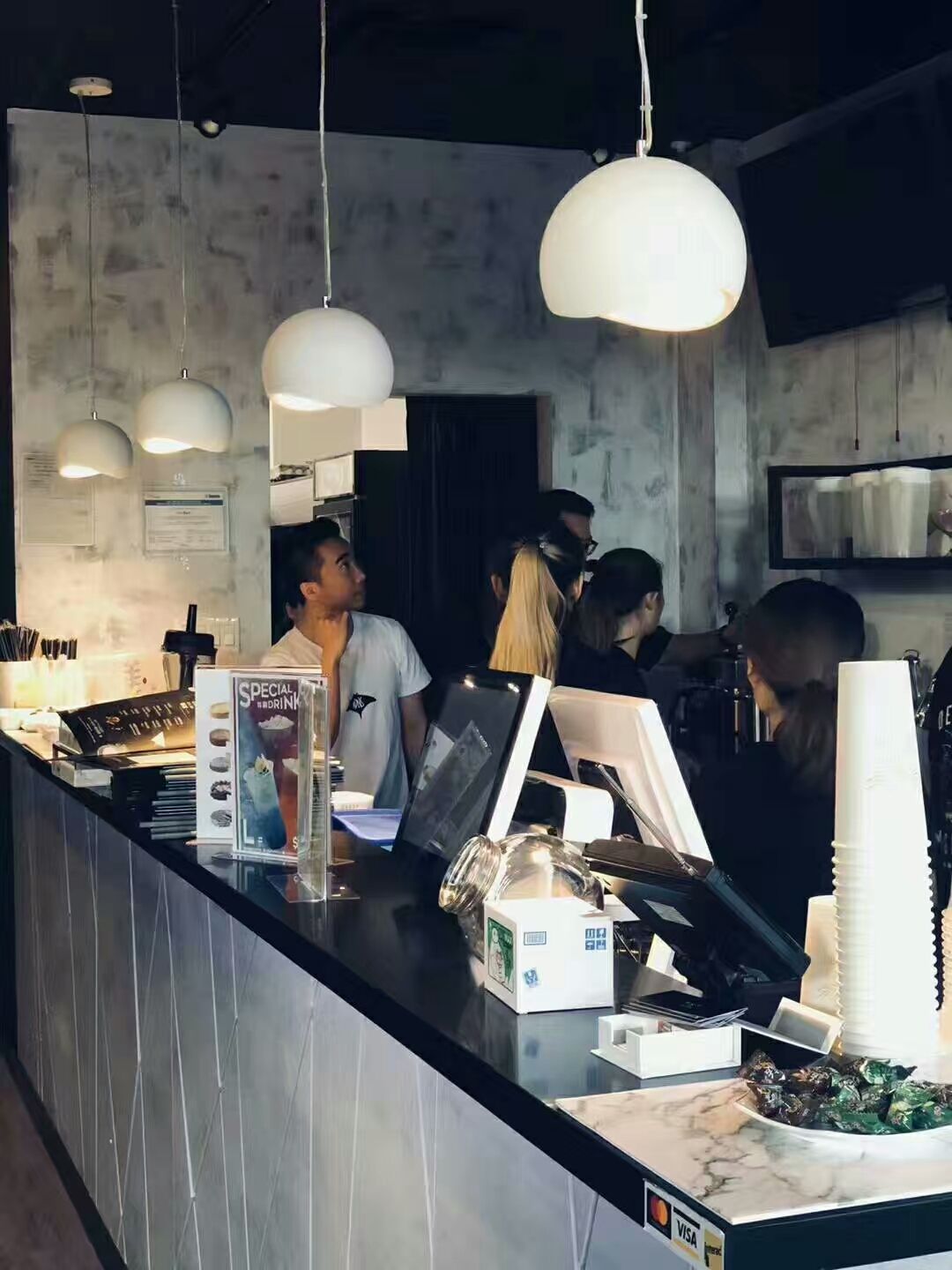 This image highlights the service counter area of a bubble tea shop renovated in Scarborough. The design features a modern marble-style countertop, clean tile finishes, and elegant pendant lighting that create a welcoming atmosphere for customers. The open counter layout improves workflow efficiency for staff while maintaining a stylish and functional commercial interior. This renovation showcases a contemporary bubble tea shop design focused on both aesthetics and customer experience.