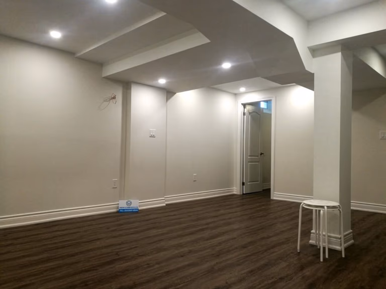 This finished basement renovation in Markham showcases a spacious open-concept layout designed for flexibility and everyday comfort. The renovation features high-quality vinyl flooring, modern recessed lighting, structural column refinishing, and a bright neutral color palette that enhances the sense of space. A newly upgraded basement bathroom and multiple storage areas improve functionality, creating a versatile lower level suitable for family living, recreation, or guest use. Completed by a trusted Toronto renovation company, this project highlights practical design and clean craftsmanship for modern homes.