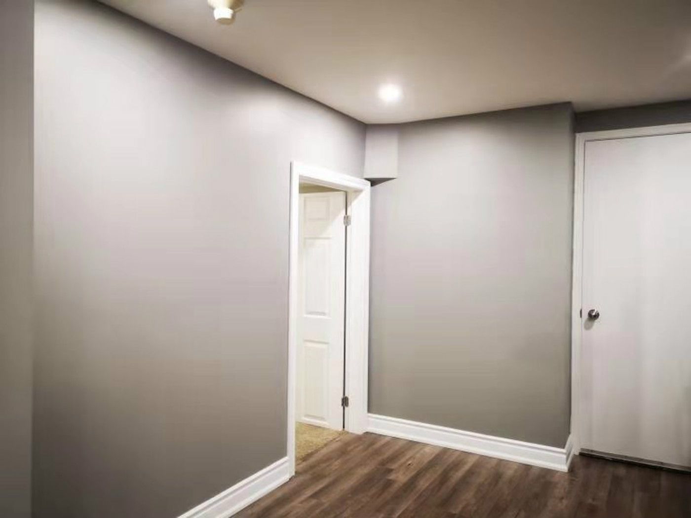 This completed Mississauga basement renovation features smooth painted walls, upgraded trim, modern vinyl flooring, and clean interior door finishes. The bright and functional layout highlights the attention to detail provided by a professional Toronto renovation company, creating a comfortable and versatile living space.