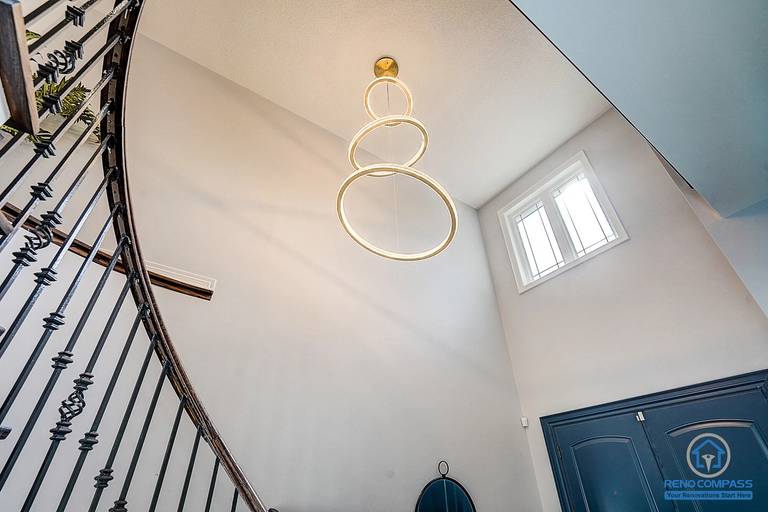 This Vaughan Maple renovation features a dramatic high-ceiling staircase with a modern chandelier and upgraded lighting design. Combined with staircase refinishing, fresh paint, and pot lights, the entry space feels brighter and more luxurious. Completed by a trusted Toronto renovation company.