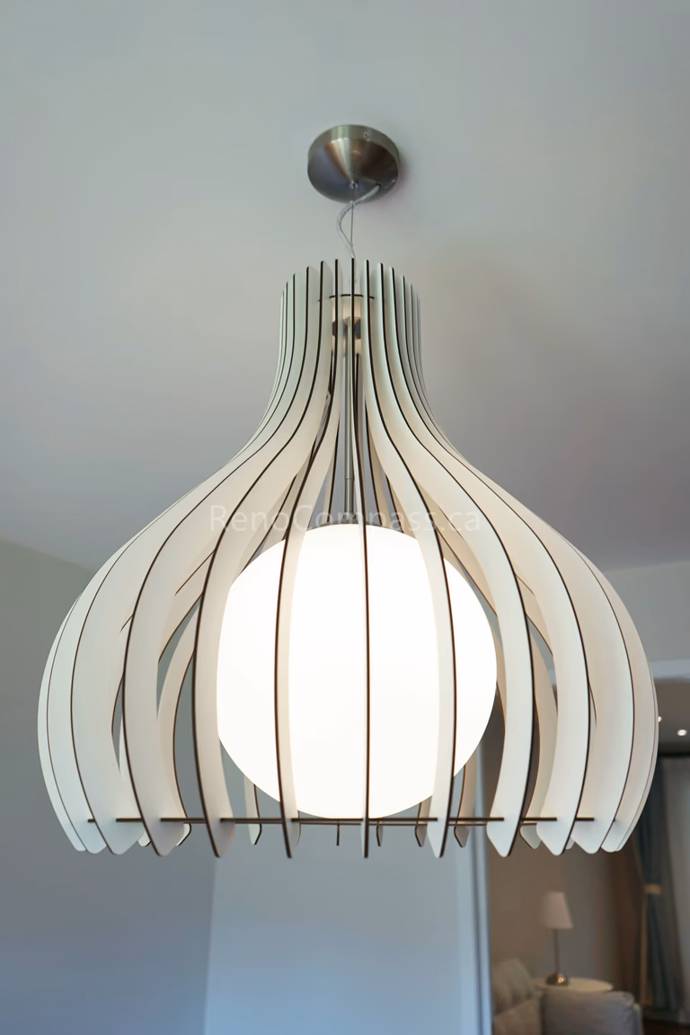 This North York interior renovation highlights a stylish modern pendant light installation that enhances the ambiance and visual appeal of the living space. The contemporary lighting fixture provides warm illumination while adding a sophisticated design element to the ceiling. Completed by Reno Compass Inc., offering professional interior renovation and lighting upgrade services throughout North York and Toronto.