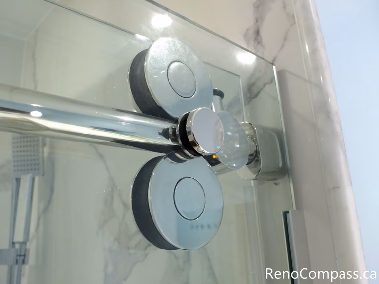 This Richmond Hill bathroom renovation highlights premium frameless glass shower door hardware with smooth sliding rollers and precision installation. Completed by a professional Toronto renovation company, the modern glass enclosure enhances durability, functionality, and sleek contemporary design, creating a refined and spacious shower experience.