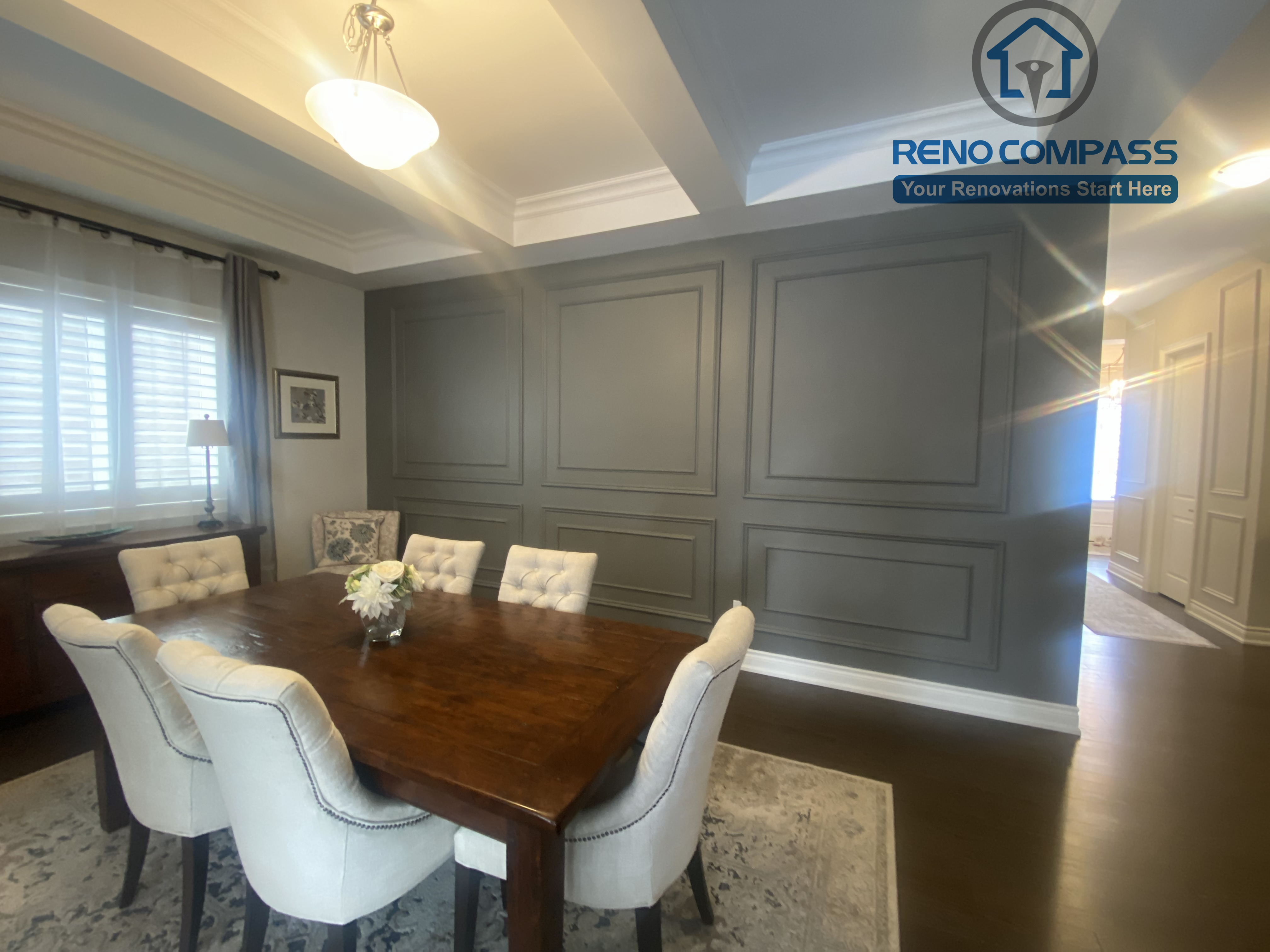 This Vaughan interior renovation features a formal dining room with custom wall paneling, coffered ceiling details, and a warm, inviting layout. The space combines classic architectural elements with refined finishes, creating an elegant setting for gatherings, completed by a professional Toronto renovation company.