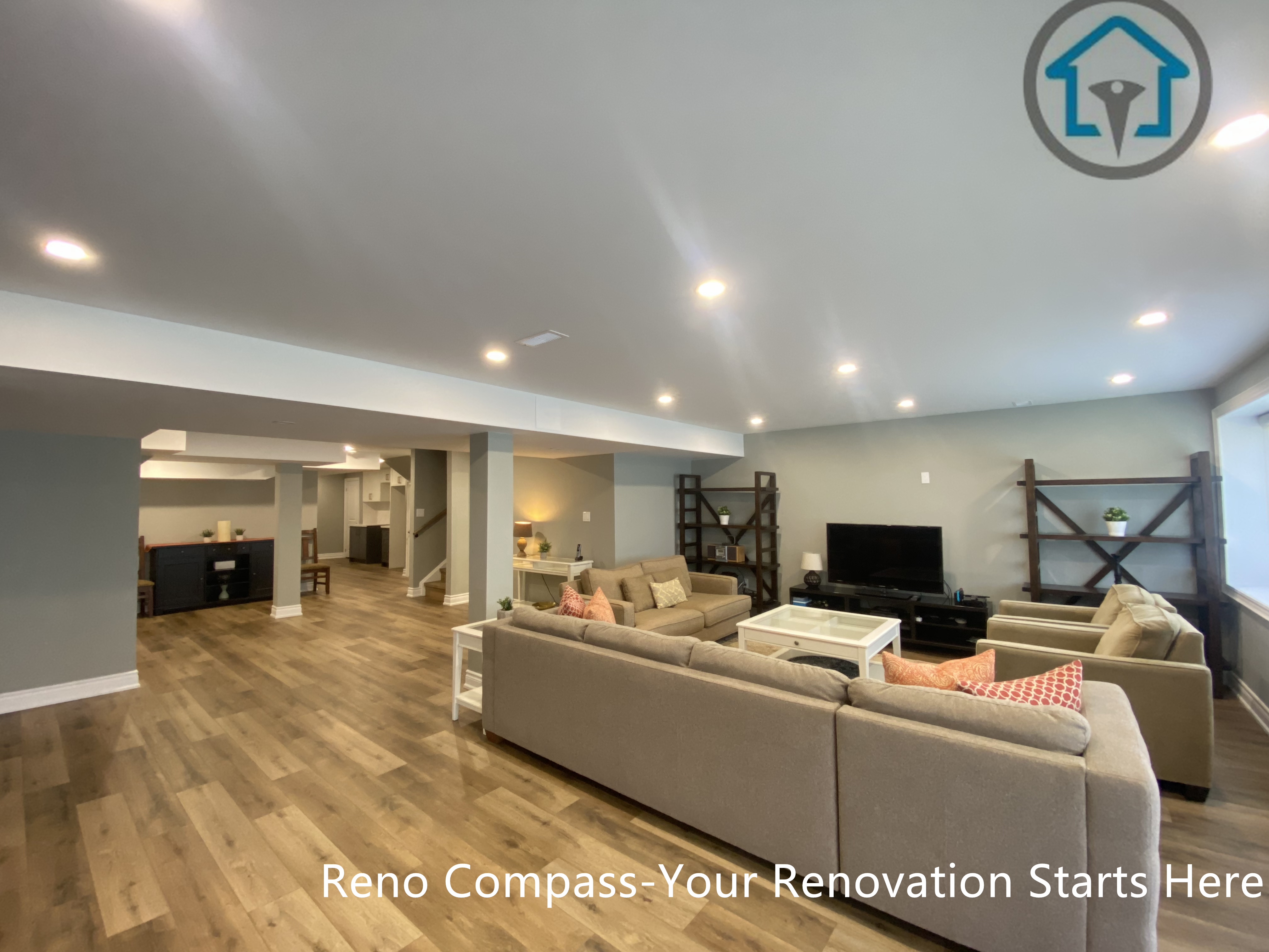 An open-concept basement living area completed as part of a Vaughan basement renovation. This finished basement features recessed ceiling lighting, integrated structural columns, durable wood-look flooring, and a spacious layout designed for family gatherings, entertainment, and everyday relaxation.
