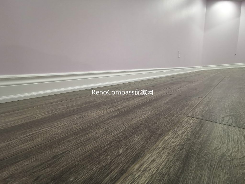 Close-up view of newly installed wood-look flooring in this Richmond Hill basement renovation project. The durable, moisture-resistant flooring was carefully installed with clean baseboard finishing to ensure long-term performance and modern aesthetics. Completed by a trusted Toronto renovation company, this upgraded basement flooring enhances comfort, visual warmth, and overall home value while providing a low-maintenance solution for everyday living.