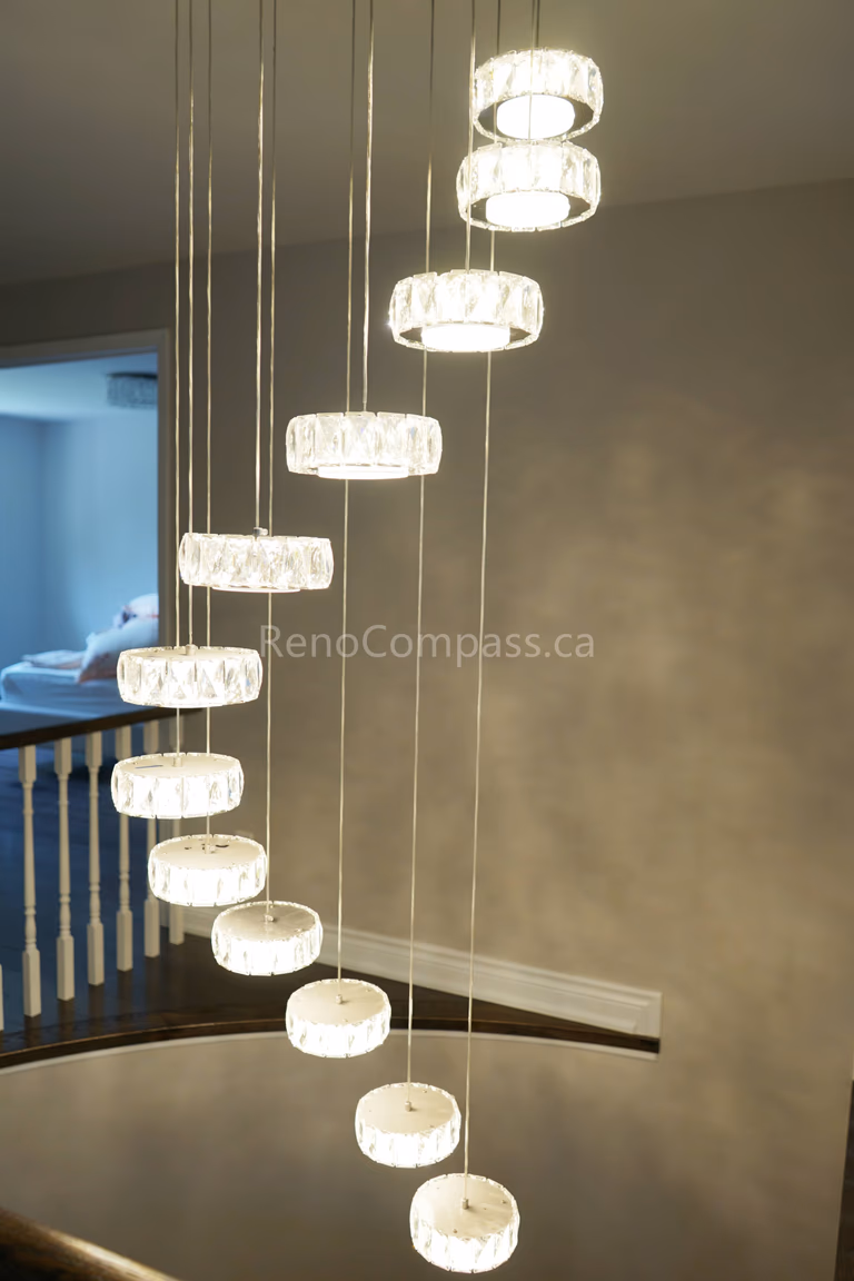 This North York interior renovation features a stunning modern chandelier installation that enhances the home’s ambiance with elegant layered lighting. The contemporary ceiling fixture provides bright, balanced illumination while adding a sophisticated focal point to the interior space. Completed by Reno Compass Inc., offering professional interior renovation and lighting upgrade services across North York and the Greater Toronto Area.